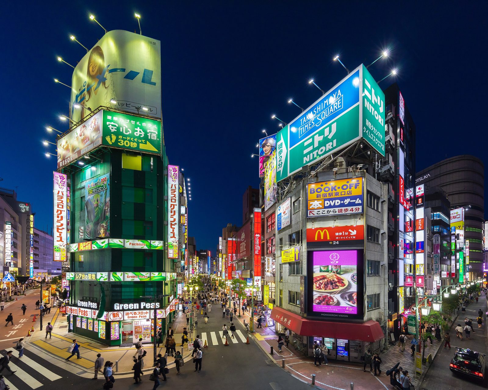 Neon signs lighting up a Shinjuku street in Tokyo at night