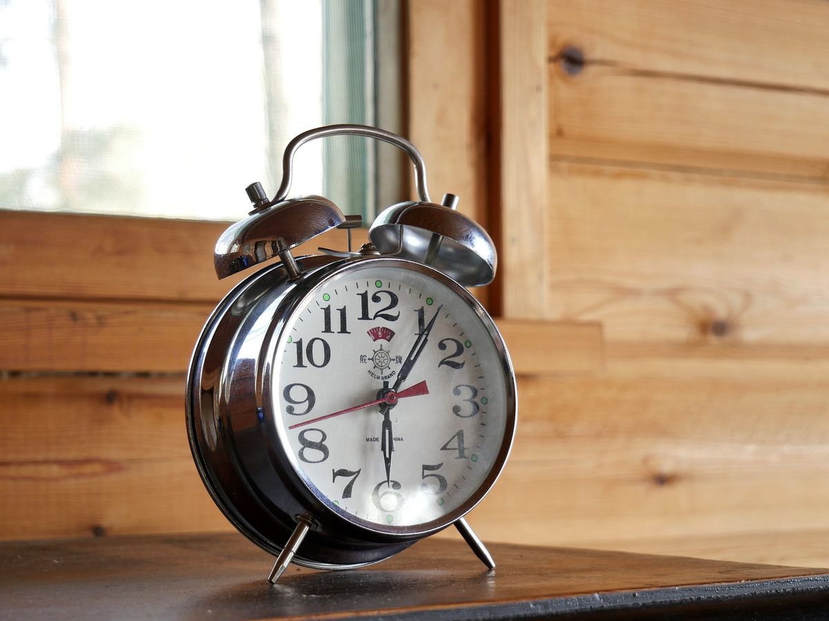A classic twin-bell alarm clock on a table