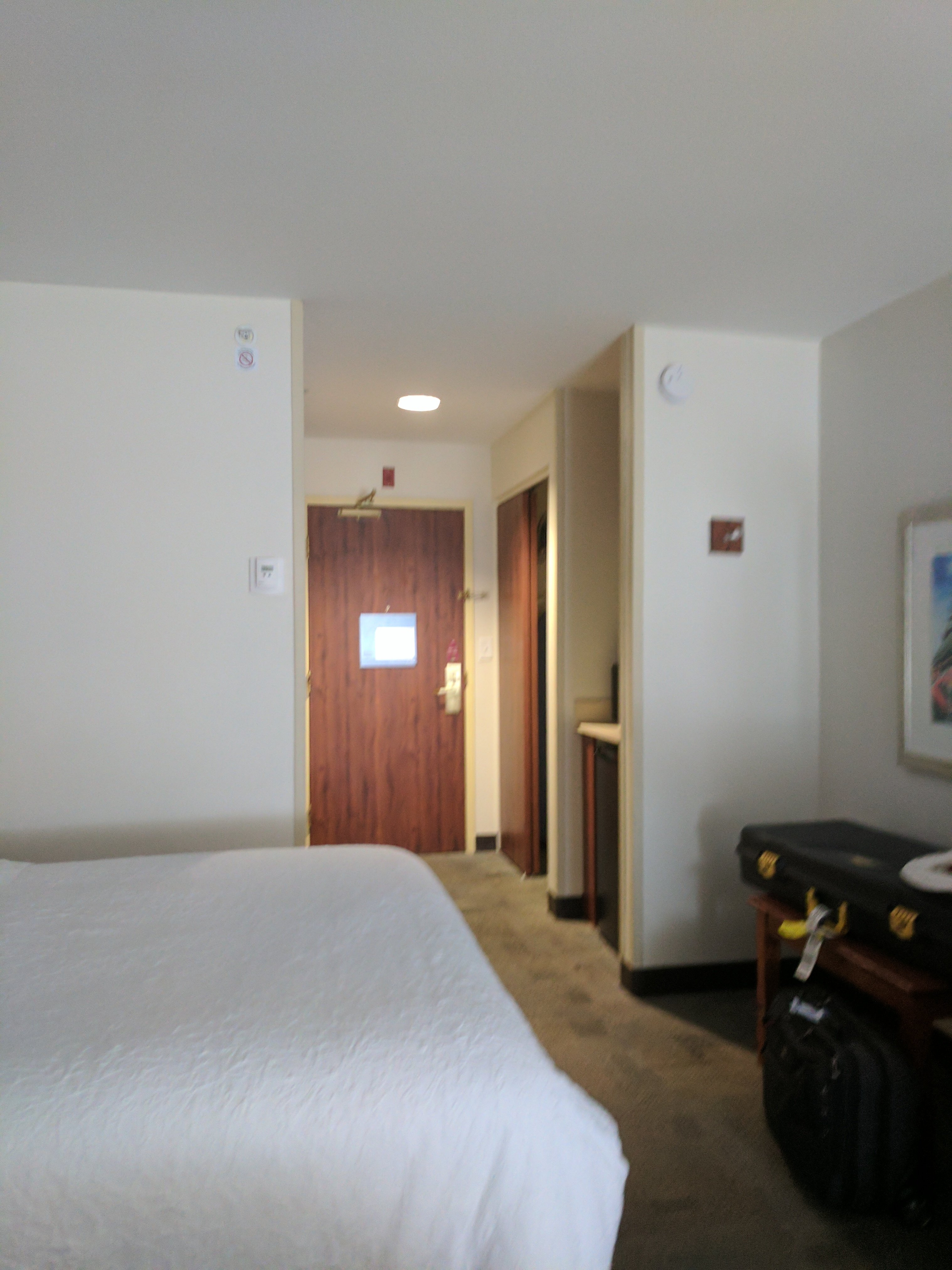 A made-up guest bed with white linen