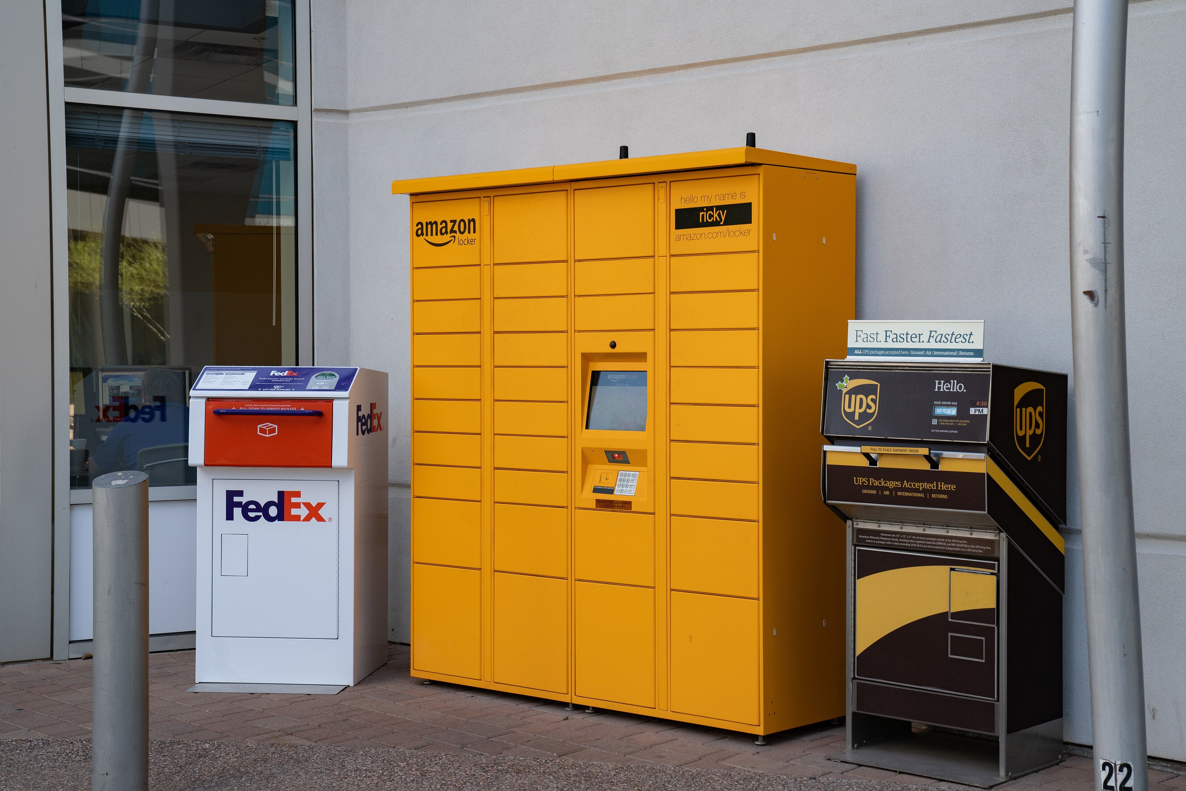 An Amazon Hub parcel locker in Tempe, Arizona, next to FedEx and UPS drop boxes