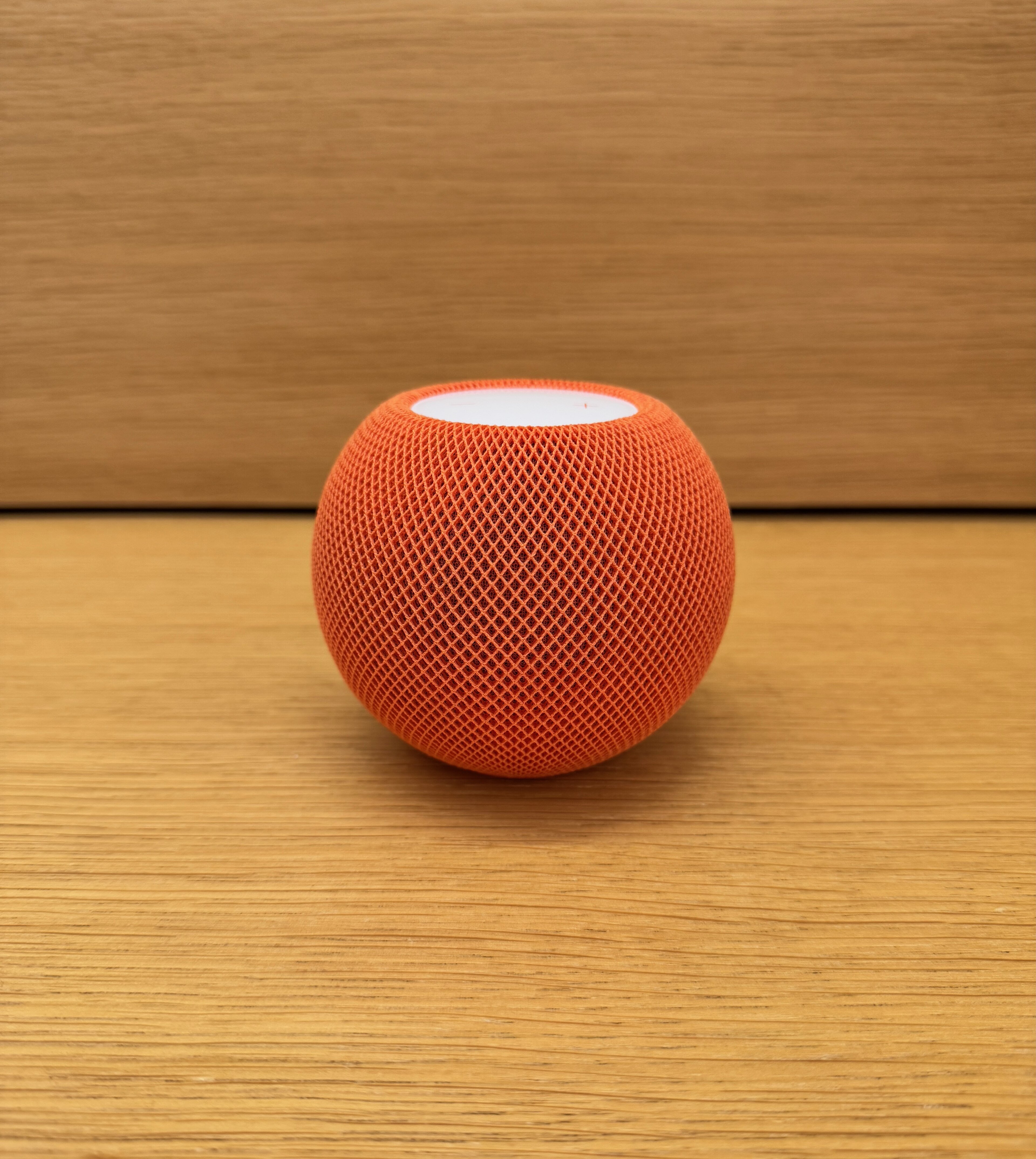A HomePod mini smart speaker, the round mesh-covered speaker Apple sells for the home