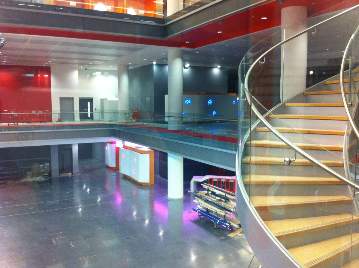 The BBC's main newsroom inside Broadcasting House in London, with glass balconies and a spiral staircase