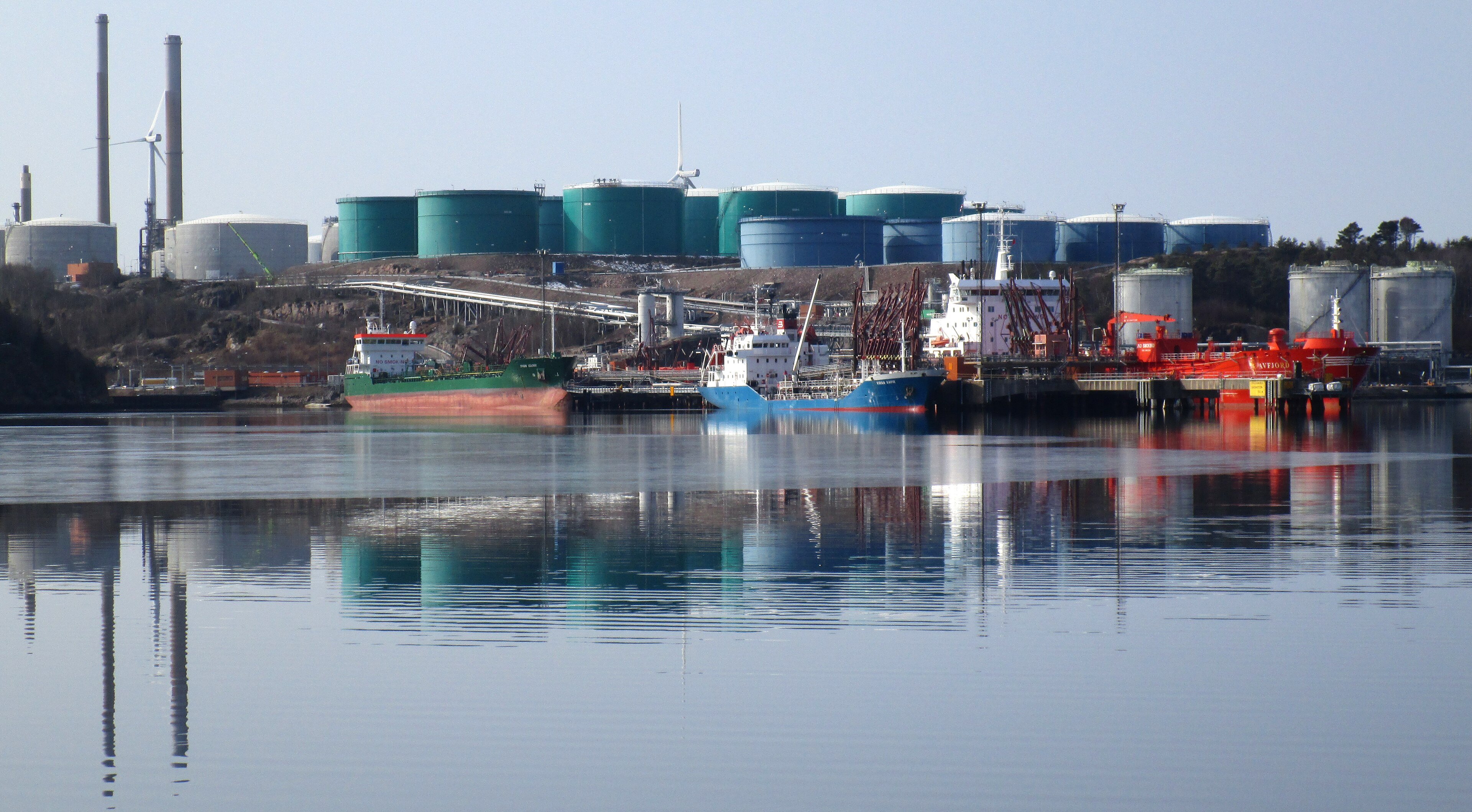 Oil tankers loading at a refinery port. Every dollar Brent crude gains ripples through what South Africa pays to import fuel