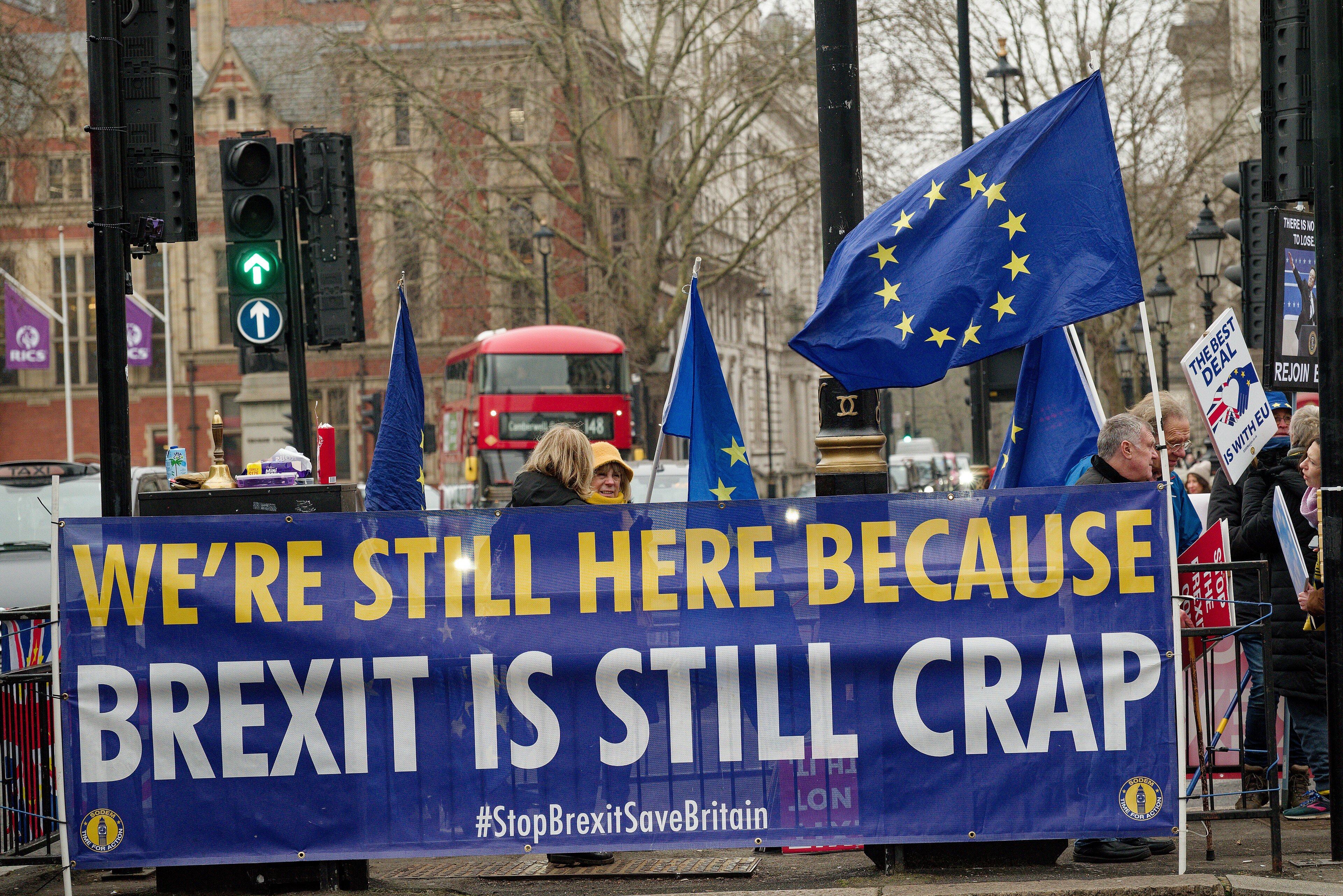 A Brexit protest in Parliament Square, London, with flags and placards