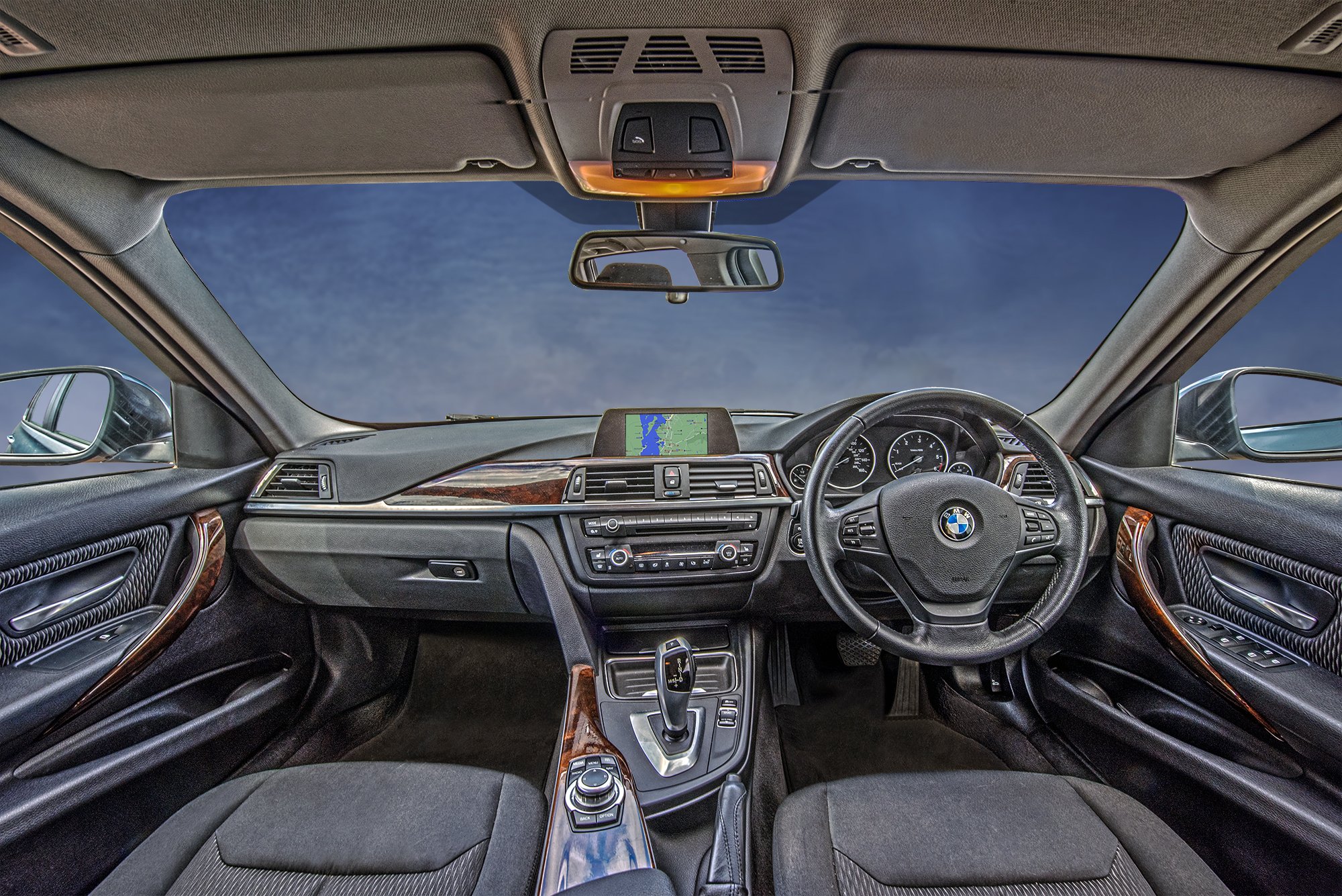 The inside of a car, the kind tourists expect when they book a ride from the airport