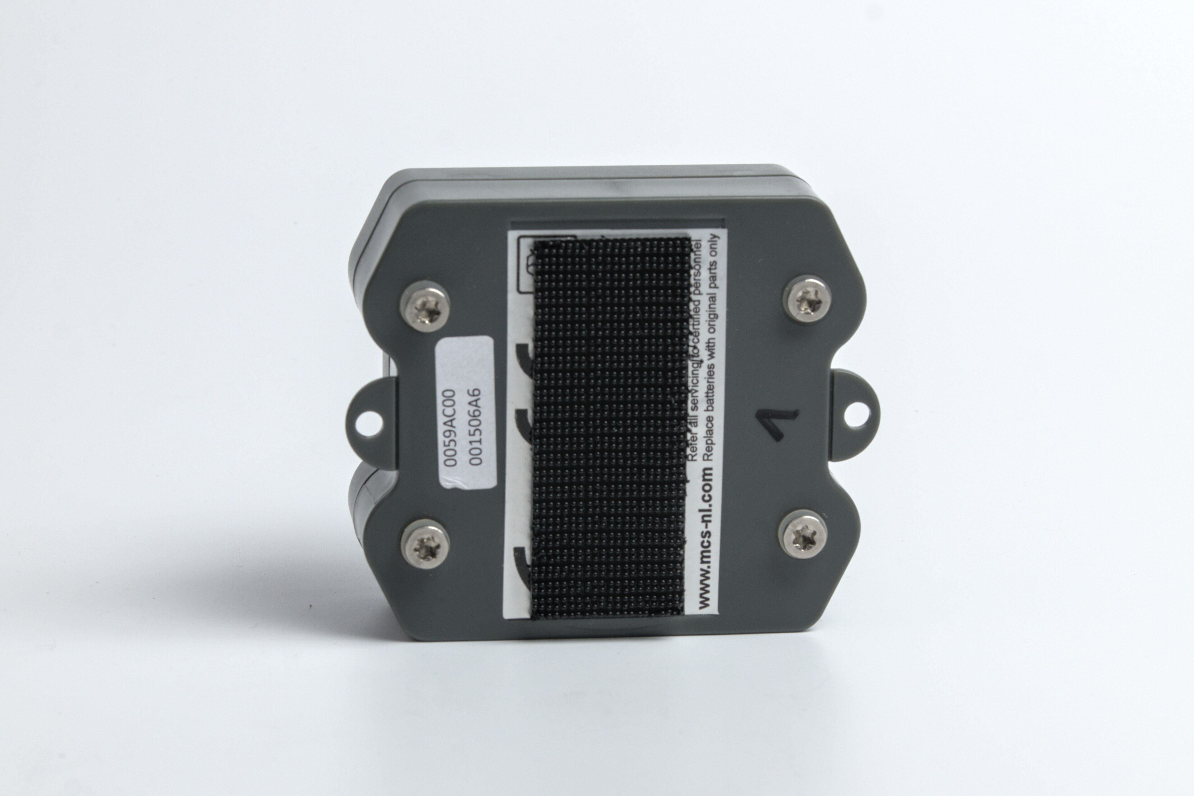 A small GPS tracking device sitting on a surface