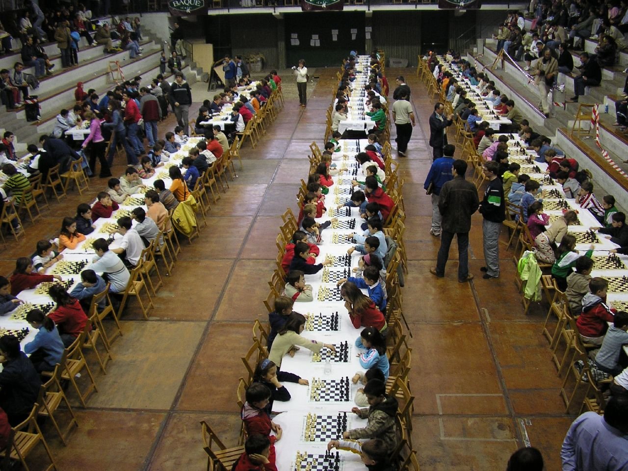 Players seated at tables during the last round of a chess tournament