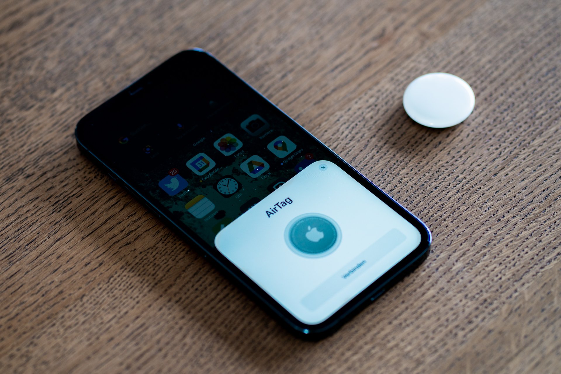 An Apple AirTag being set up with an iPhone