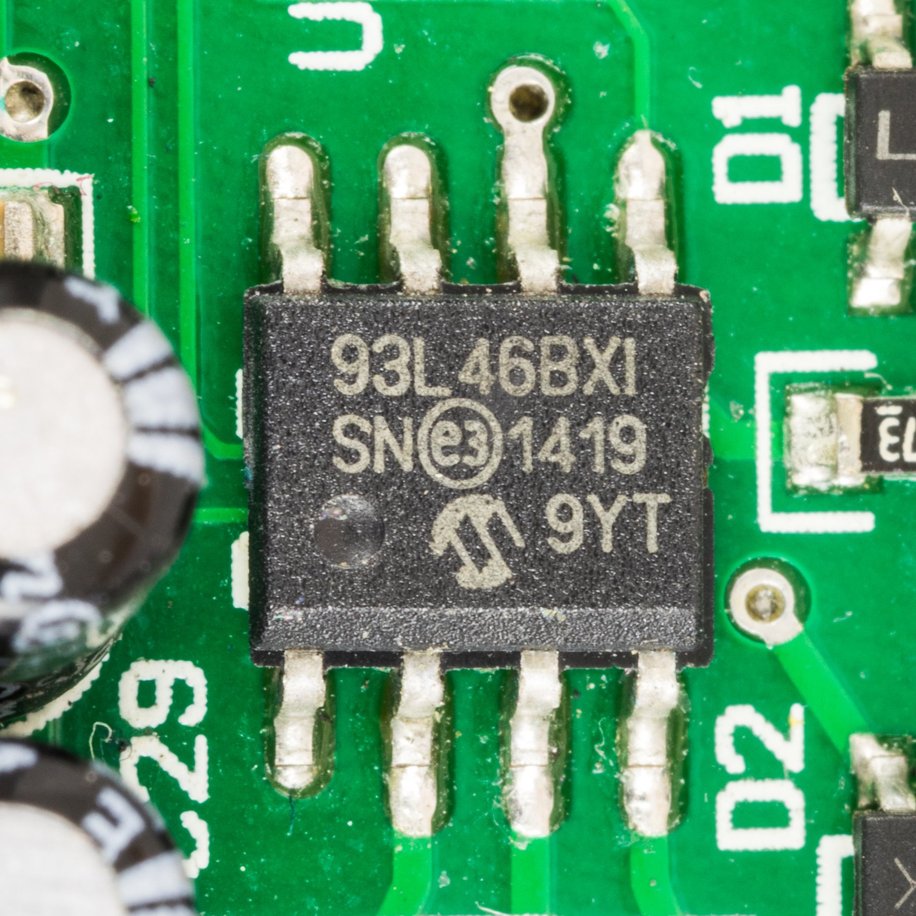 A tiny chip on a green circuit board