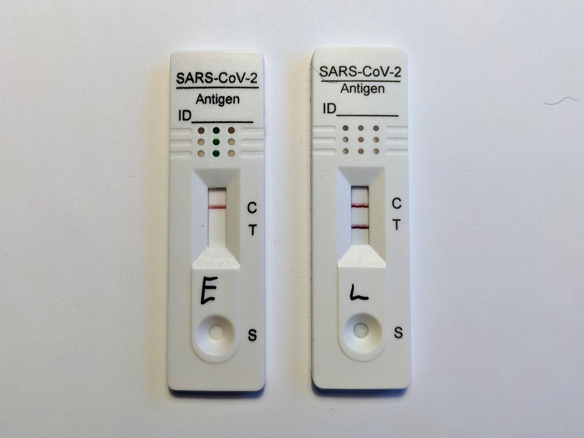 Two lateral flow Covid tests side by side, one negative and one positive