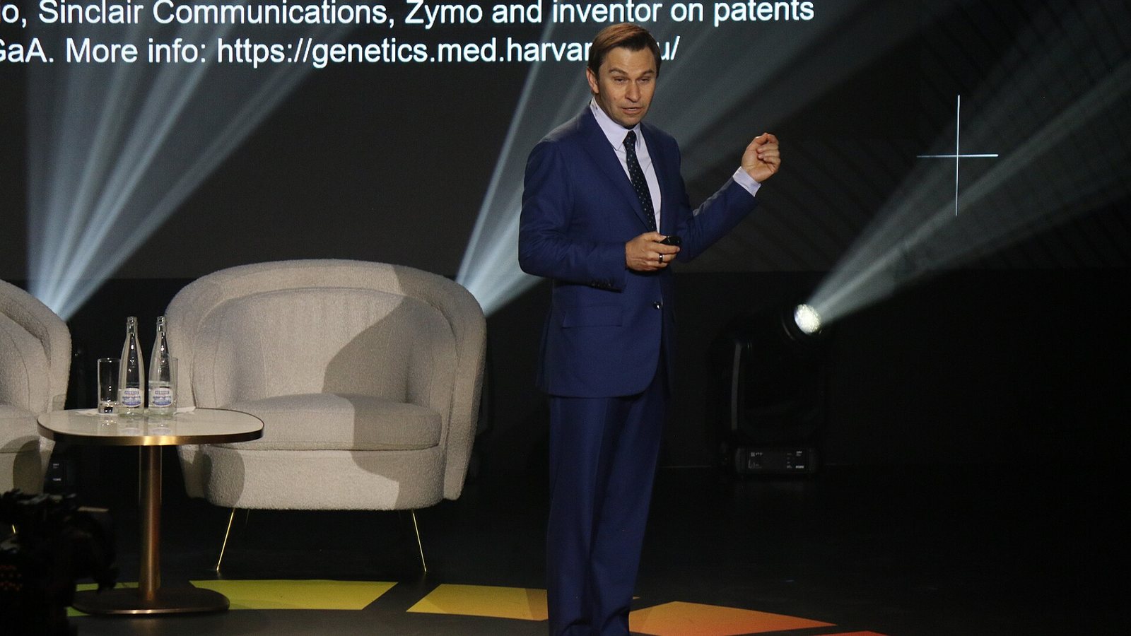 Harvard aging researcher David Sinclair in a blue suit speaking on stage at the 2025 UN AI for Good Summit in Geneva