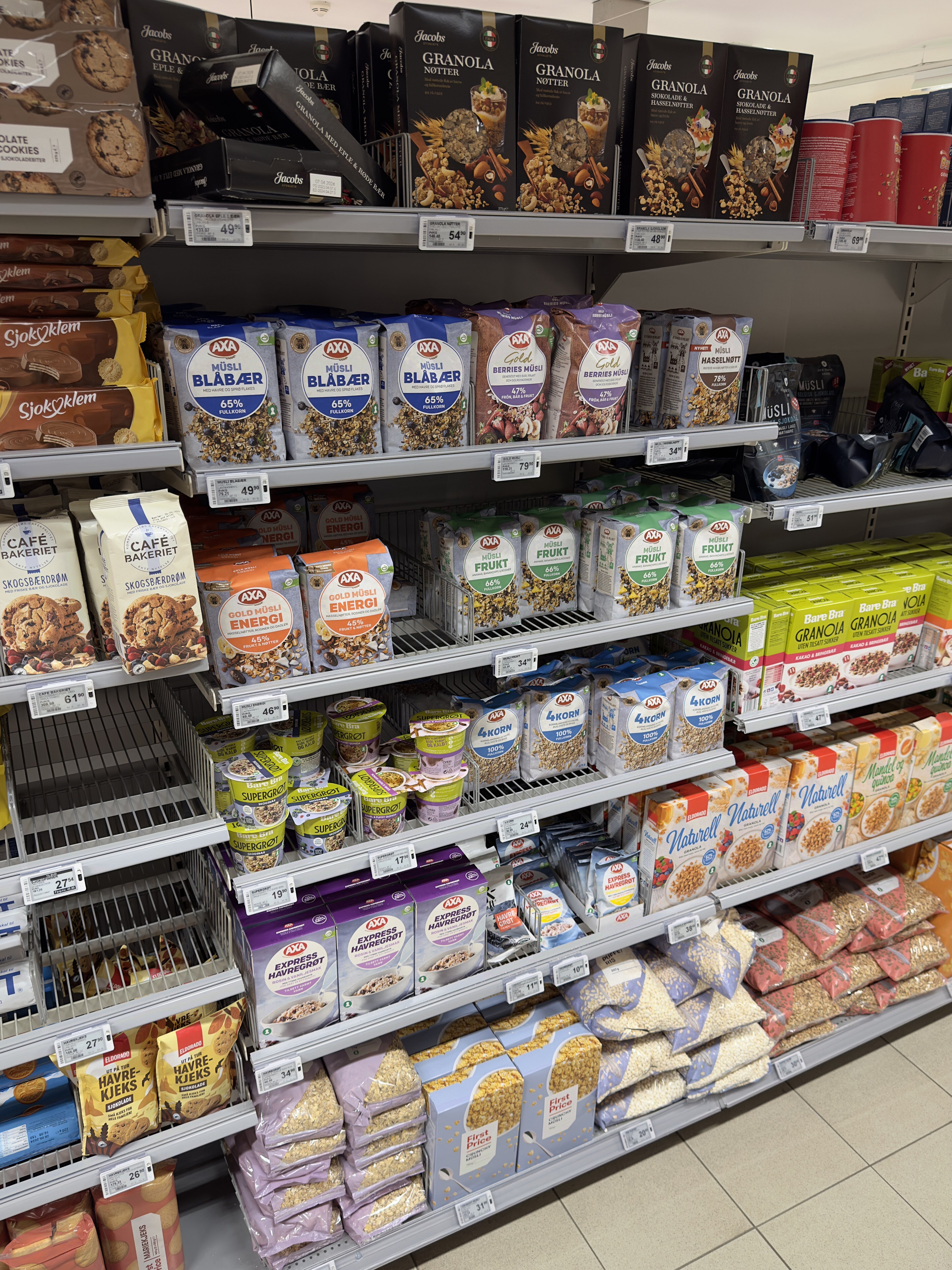 Grocery shelves stocked with packaged food, price tags visible