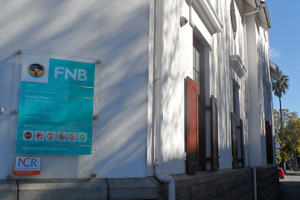 An FNB branch sign on a whitewashed wall in Paarl