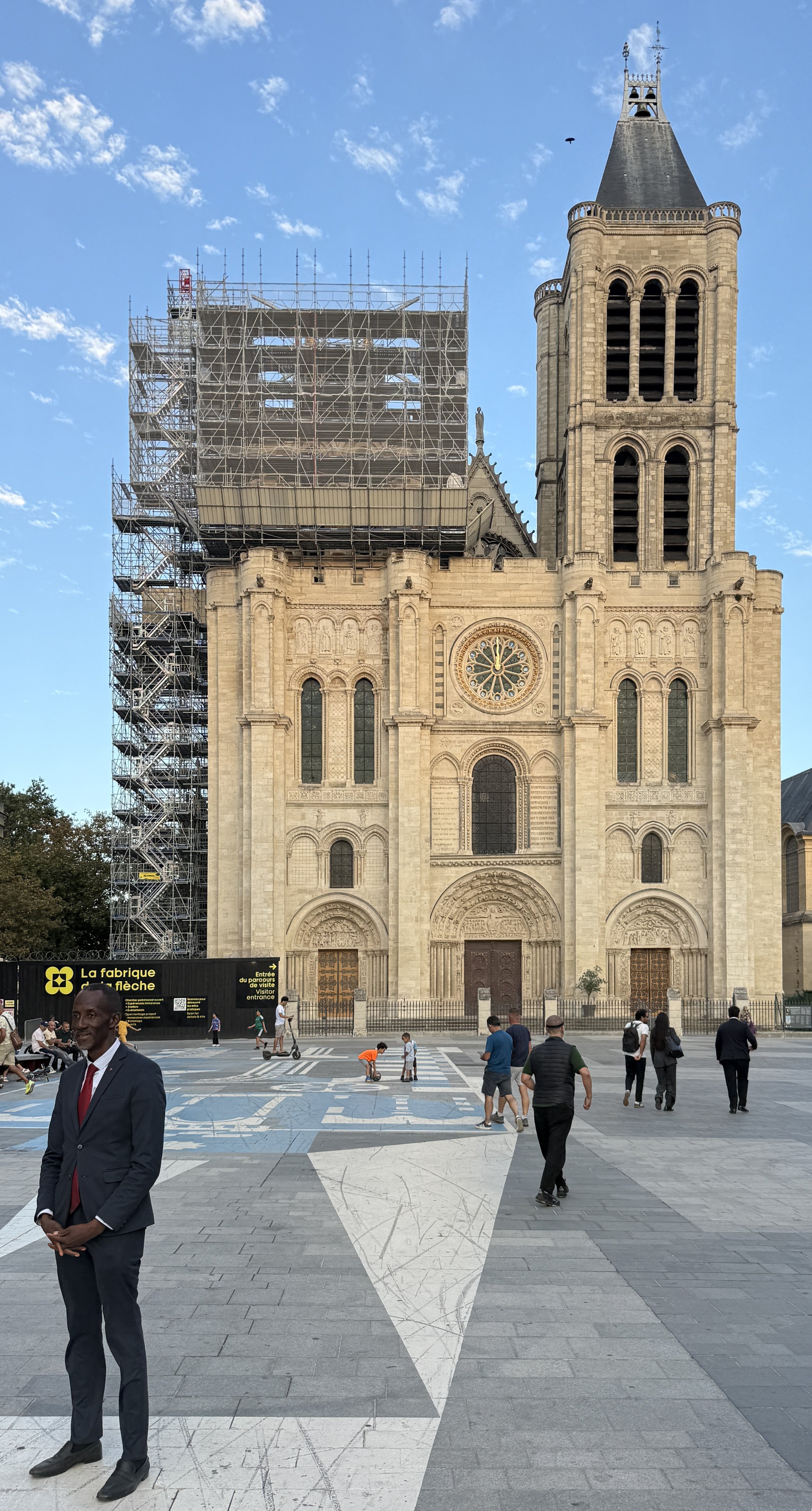 Bally Bagayoko walks across the square in front of the Basilica of Saint-Denis