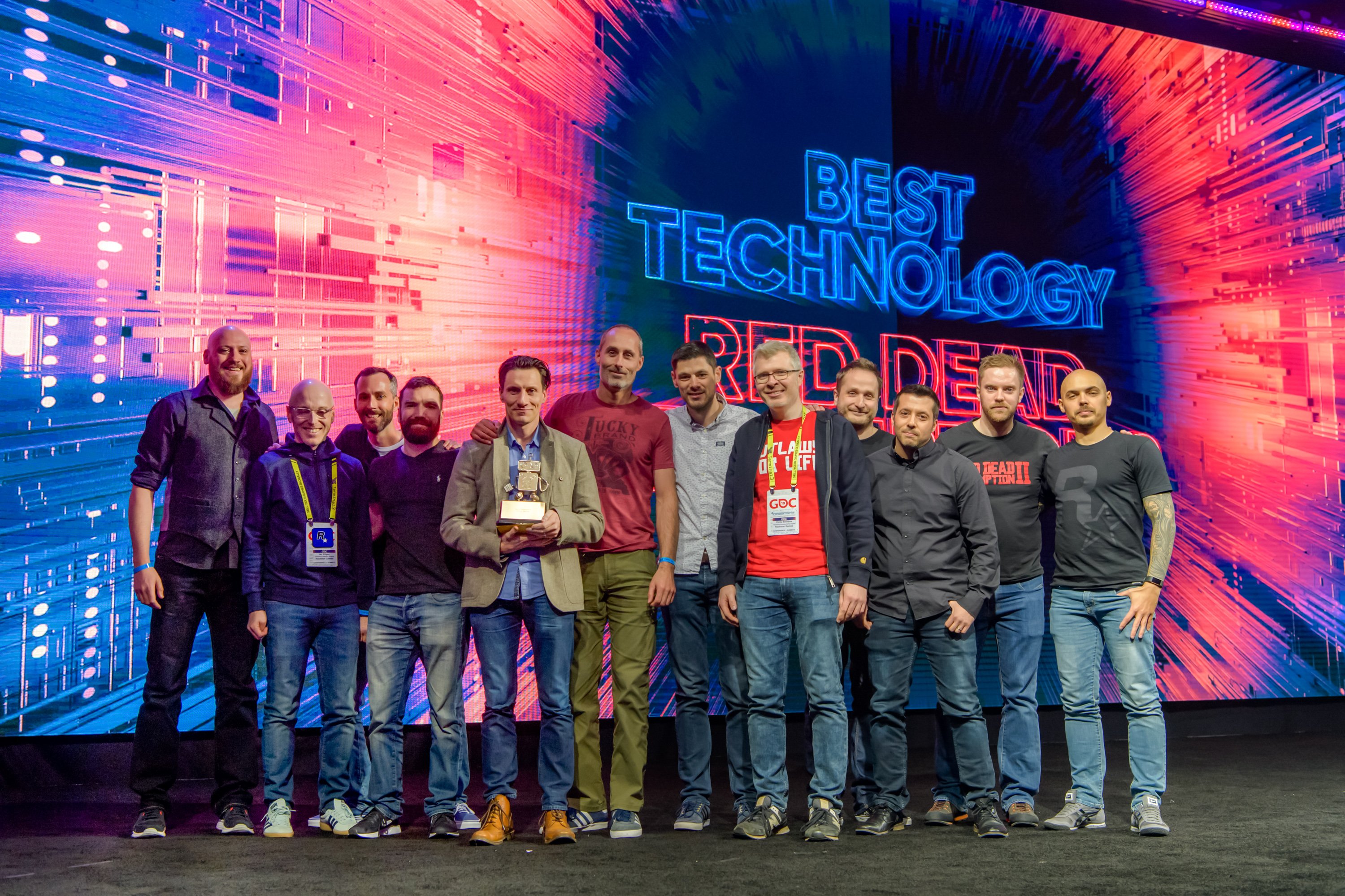 Members of the Rockstar Games team on stage at the 2019 Game Developers Choice Awards holding the Best Technology award for Red Dead Redemption 2
