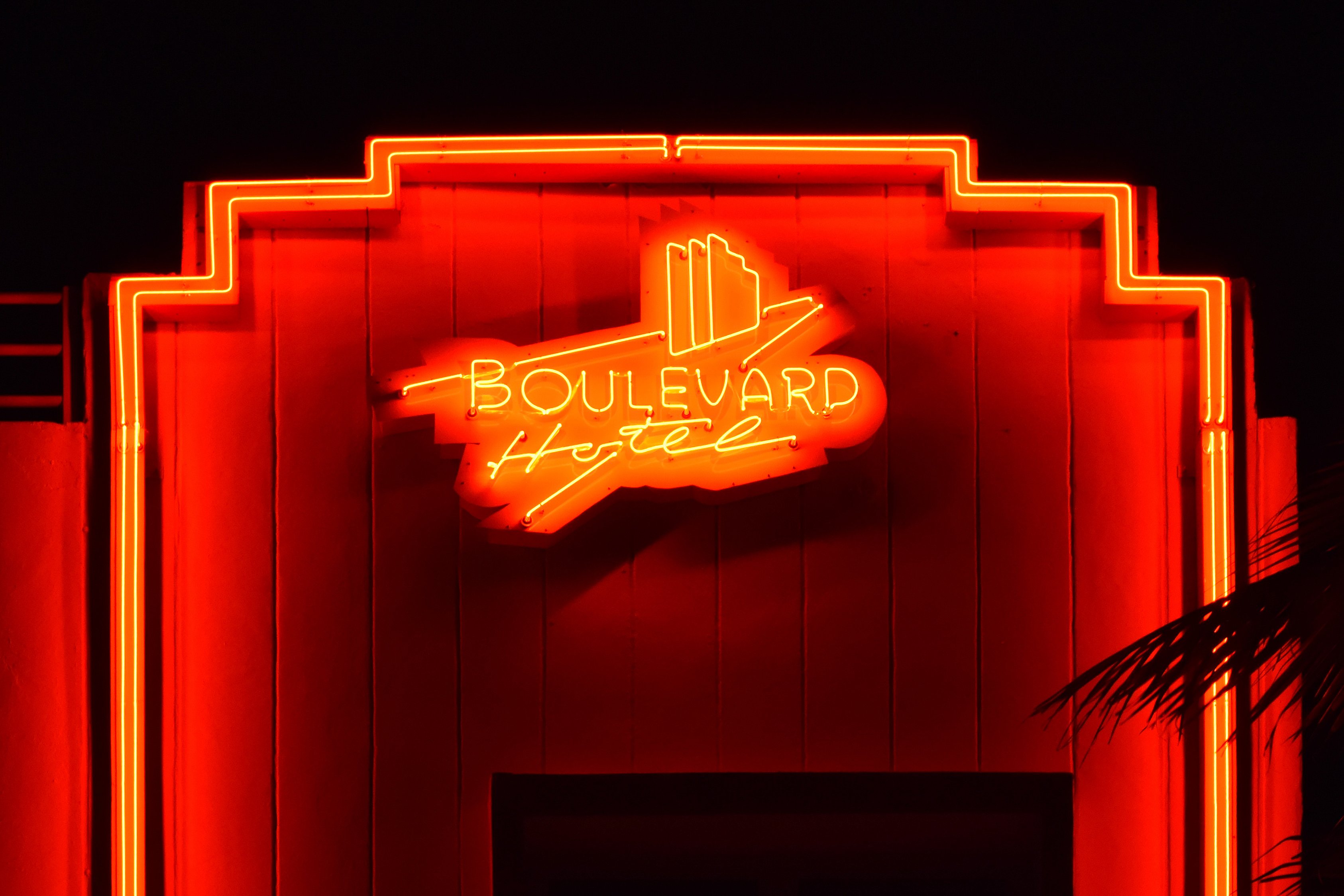 The glowing neon sign of the Boulevard Hotel on Miami Beach at night