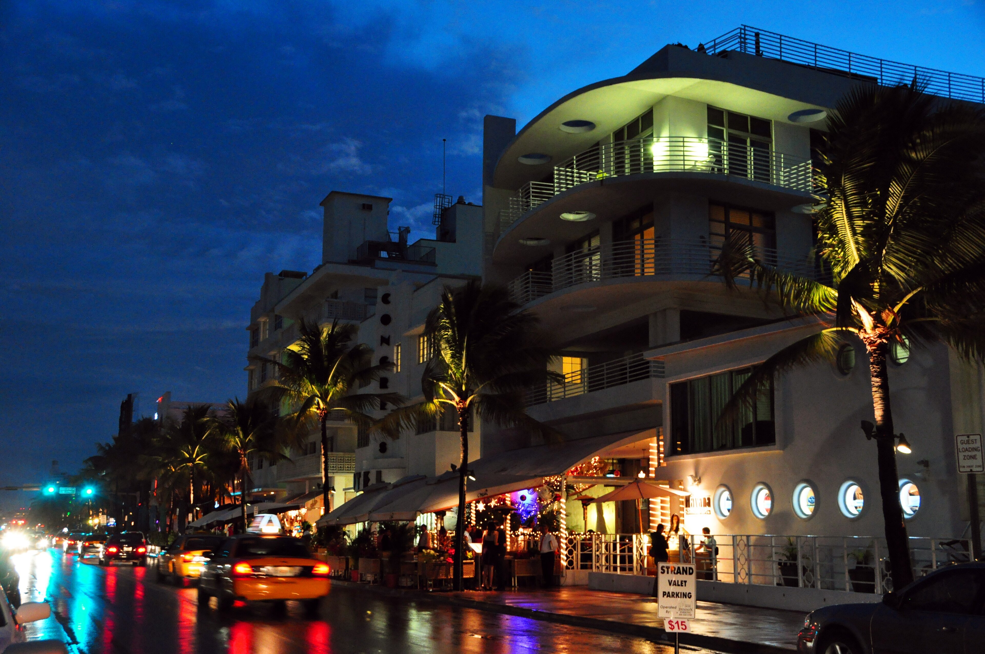Ocean Drive in South Beach, Miami, at night with pink and blue neon hotel signs, the real street that inspired Vice City