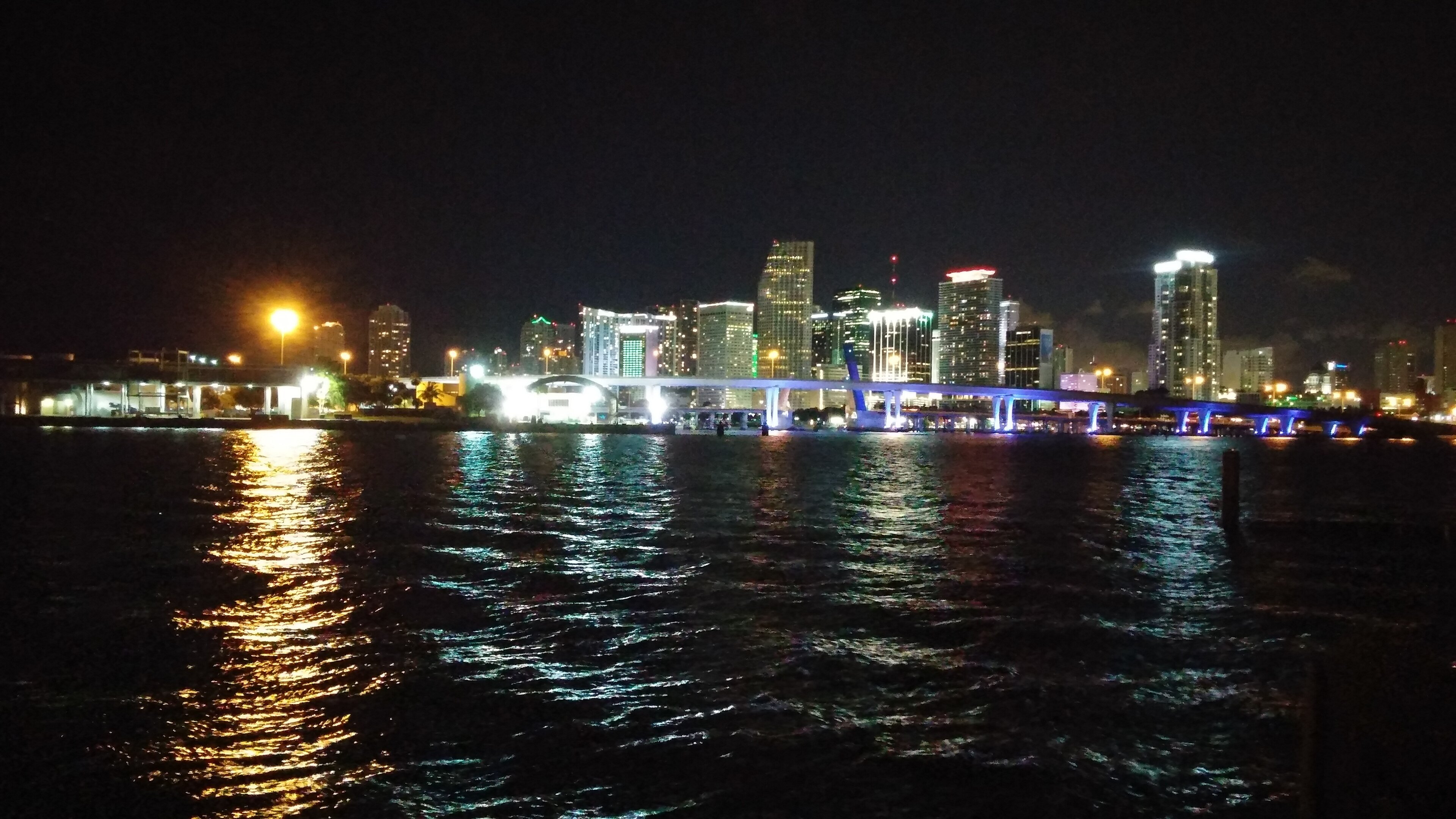 Downtown Miami lit up at night across the bay, the real city behind GTA 6's Vice City