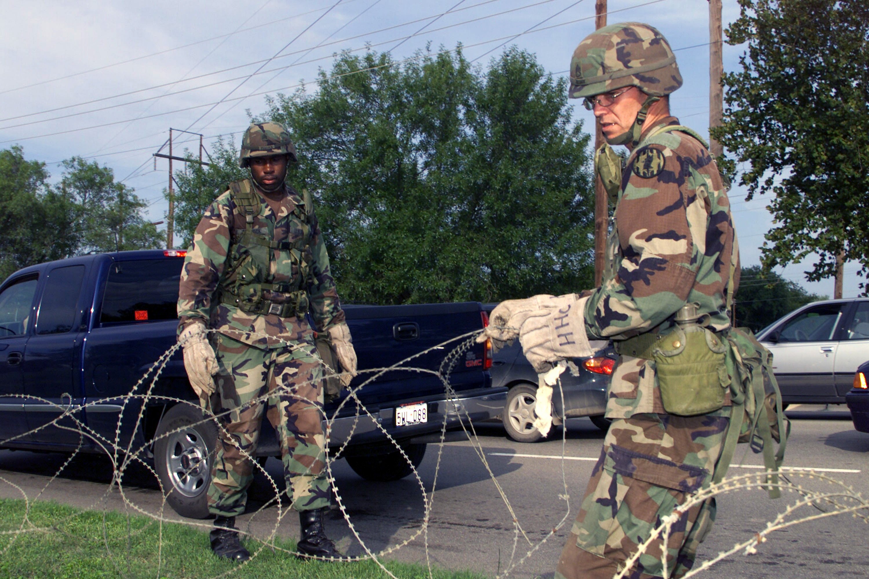 US Army soldiers setting up a wire barrier at the main gate of Fort Hood, Texas