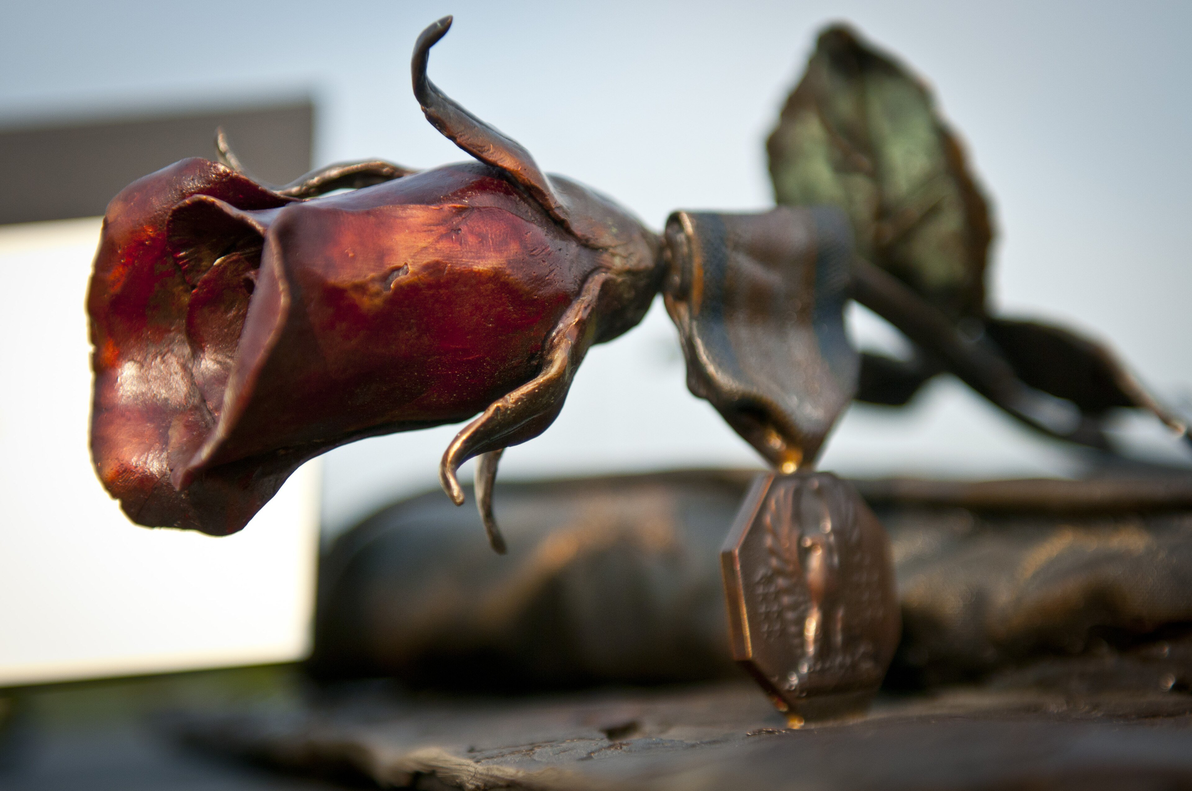 A bronze sculpture with a rose and a medal at the Fort Hood shooting memorial