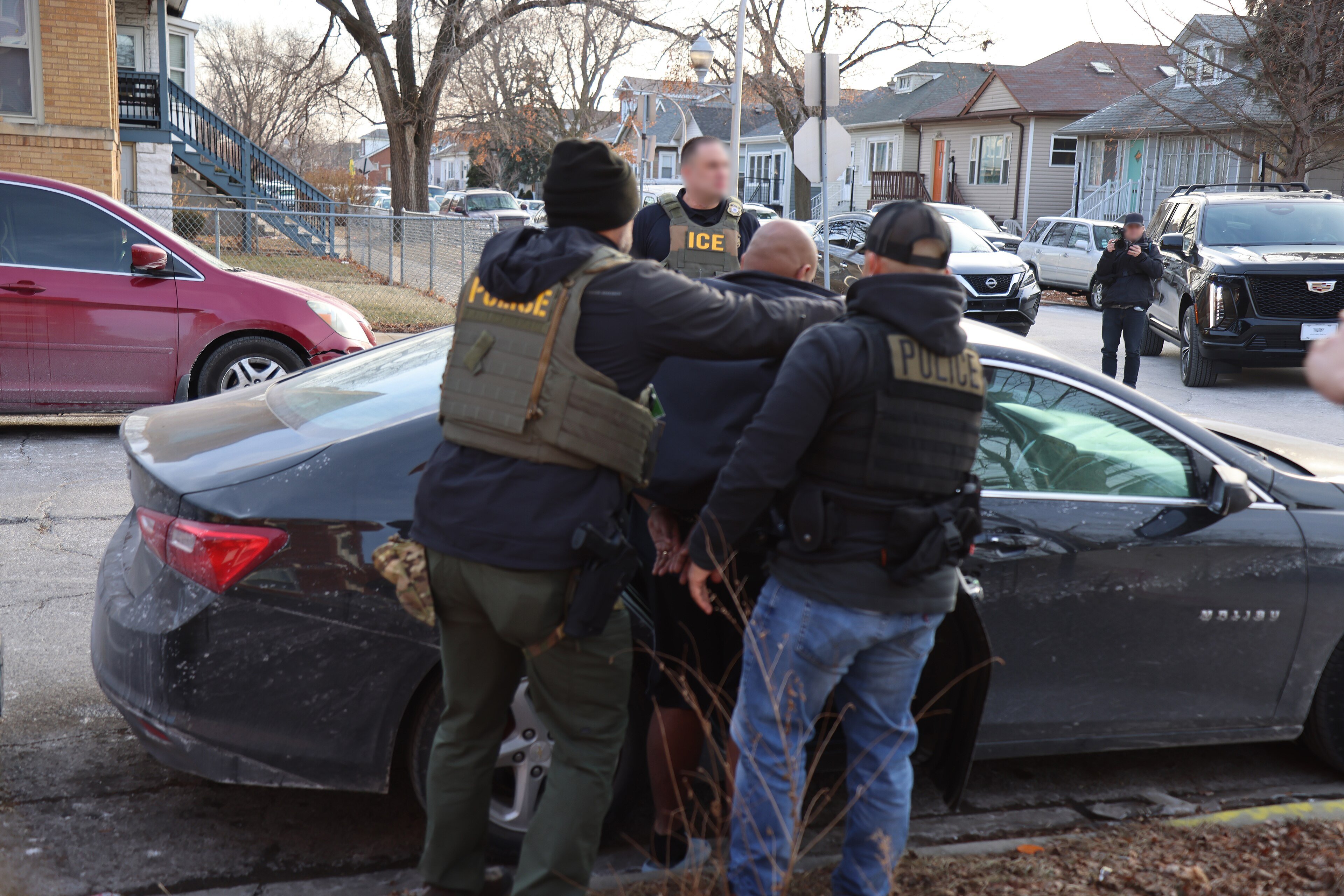 ICE Enforcement and Removal Operations officers in tactical vests during an operation in Chicago in January 2025