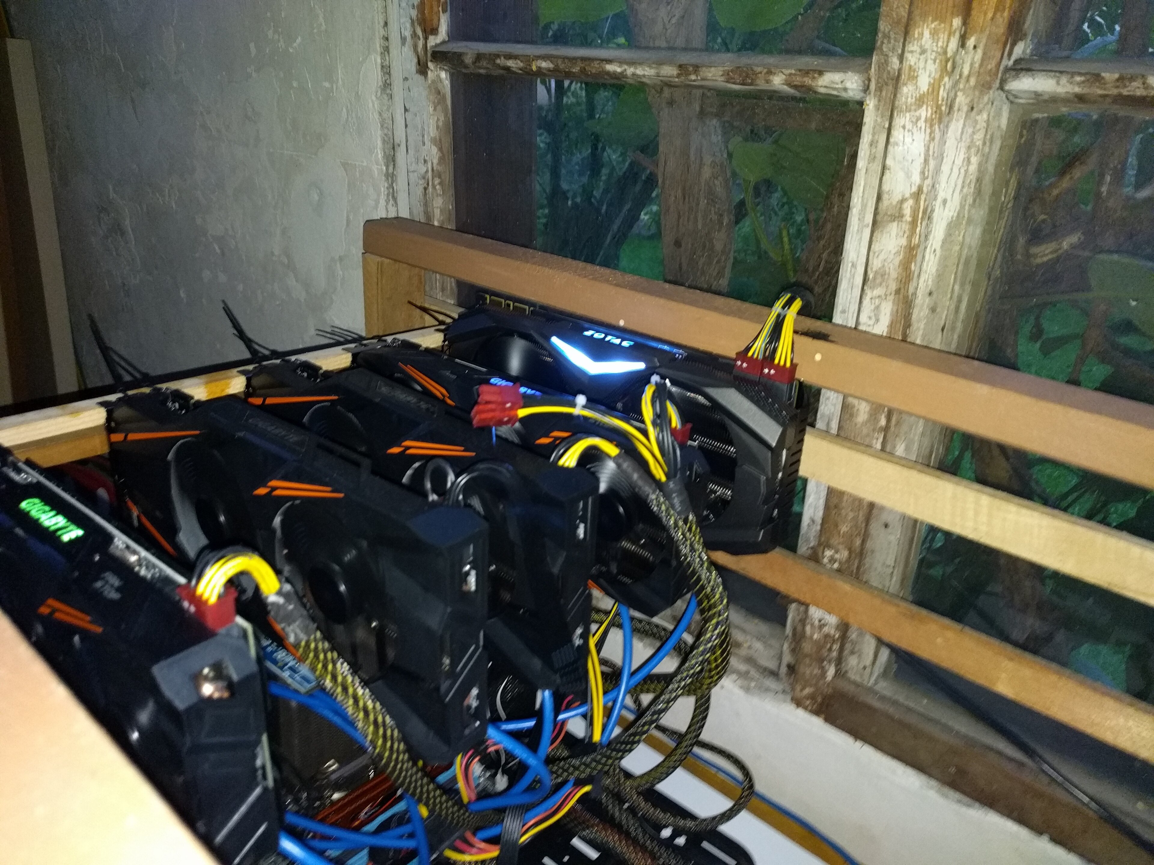 A cryptocurrency mining rig with multiple graphics cards and fans