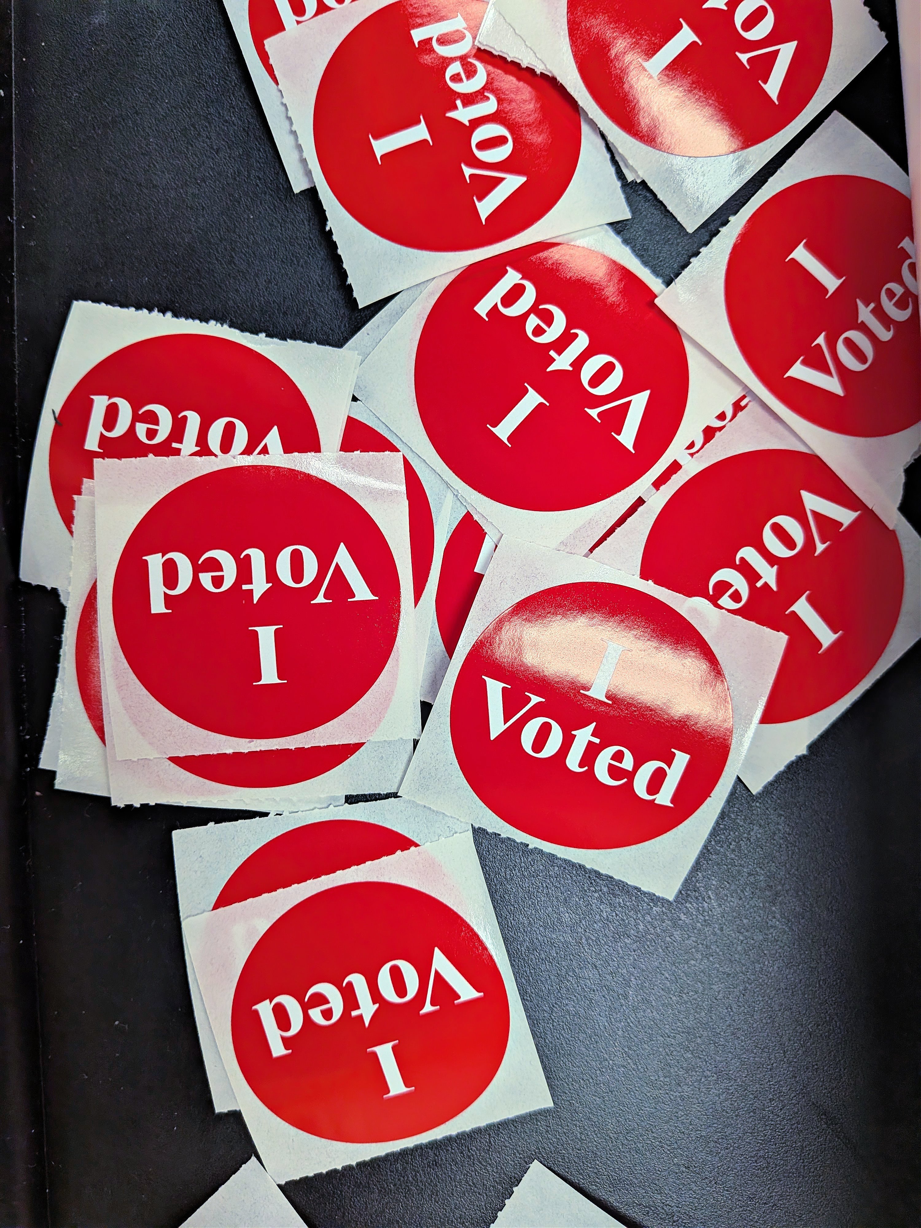 A pile of I Voted stickers at a polling station