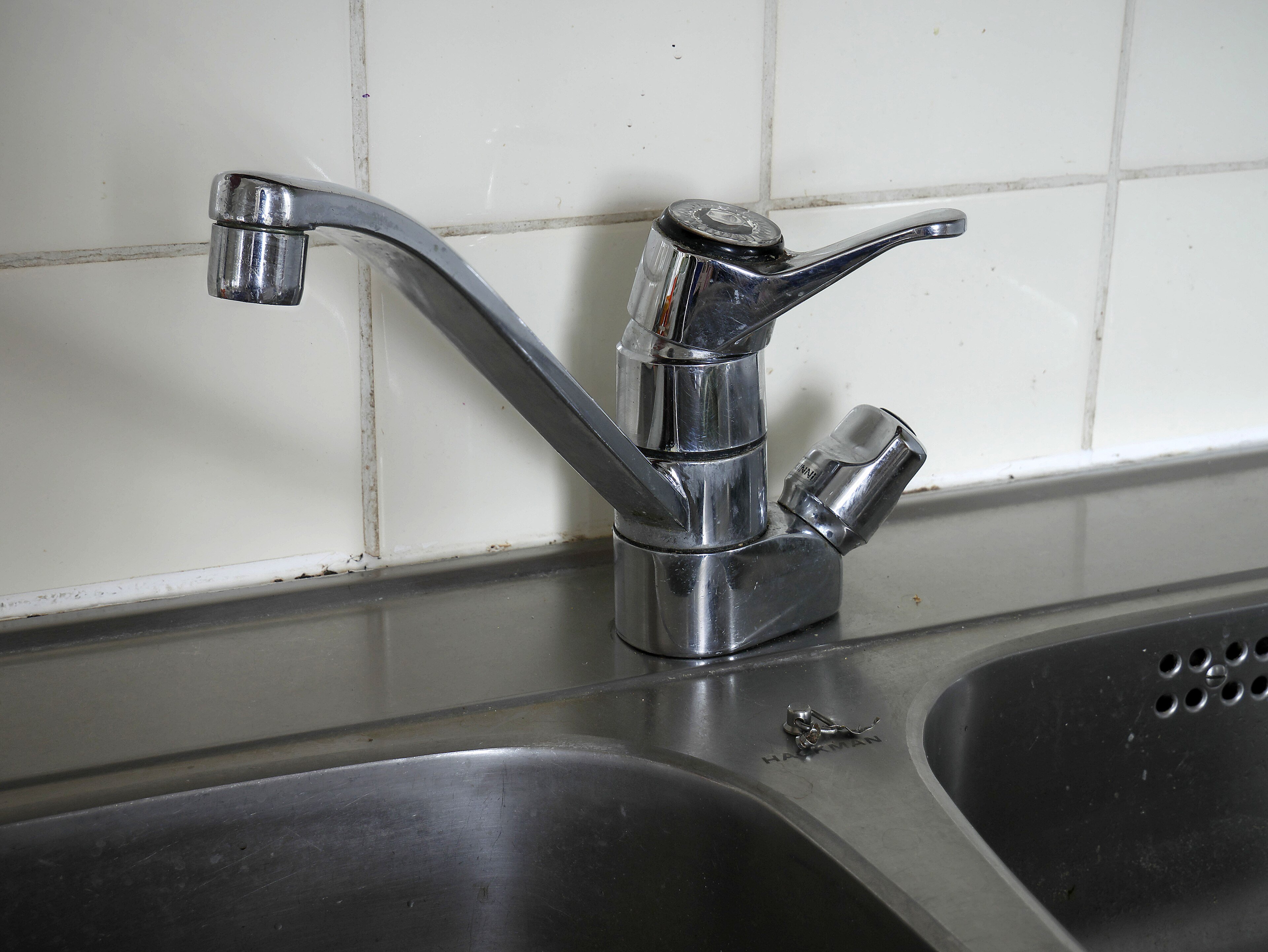 A kitchen water tap, closed