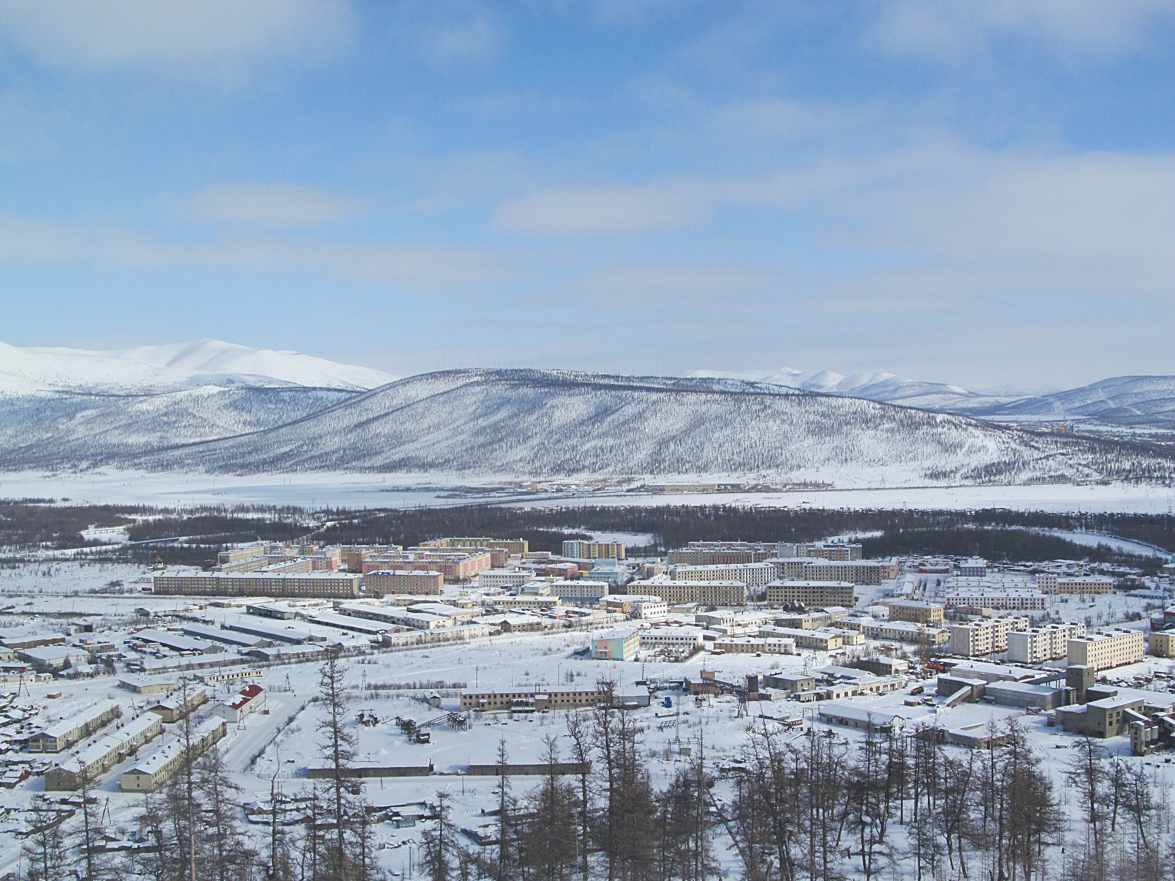 The small town of Bilibino in Chukotka, far east Russia, with snowy hills around it