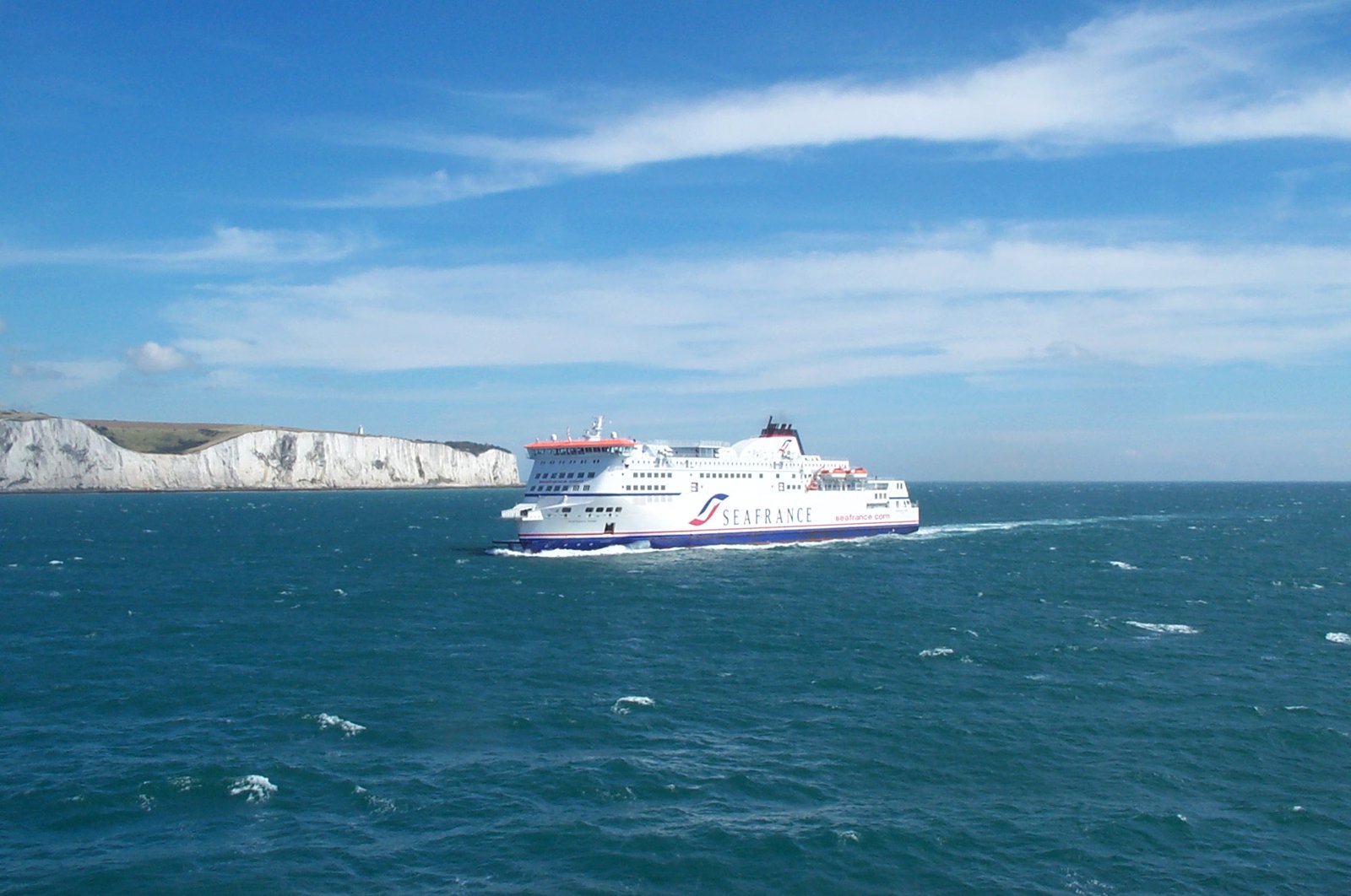 A ferry crossing the English Channel with the white cliffs of Dover in the background