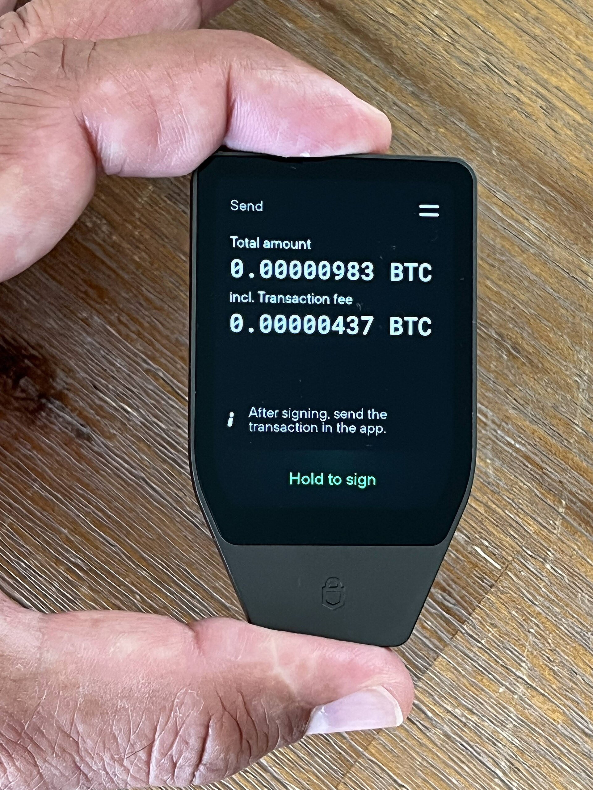 A hardware wallet screen showing a transaction to check before approving