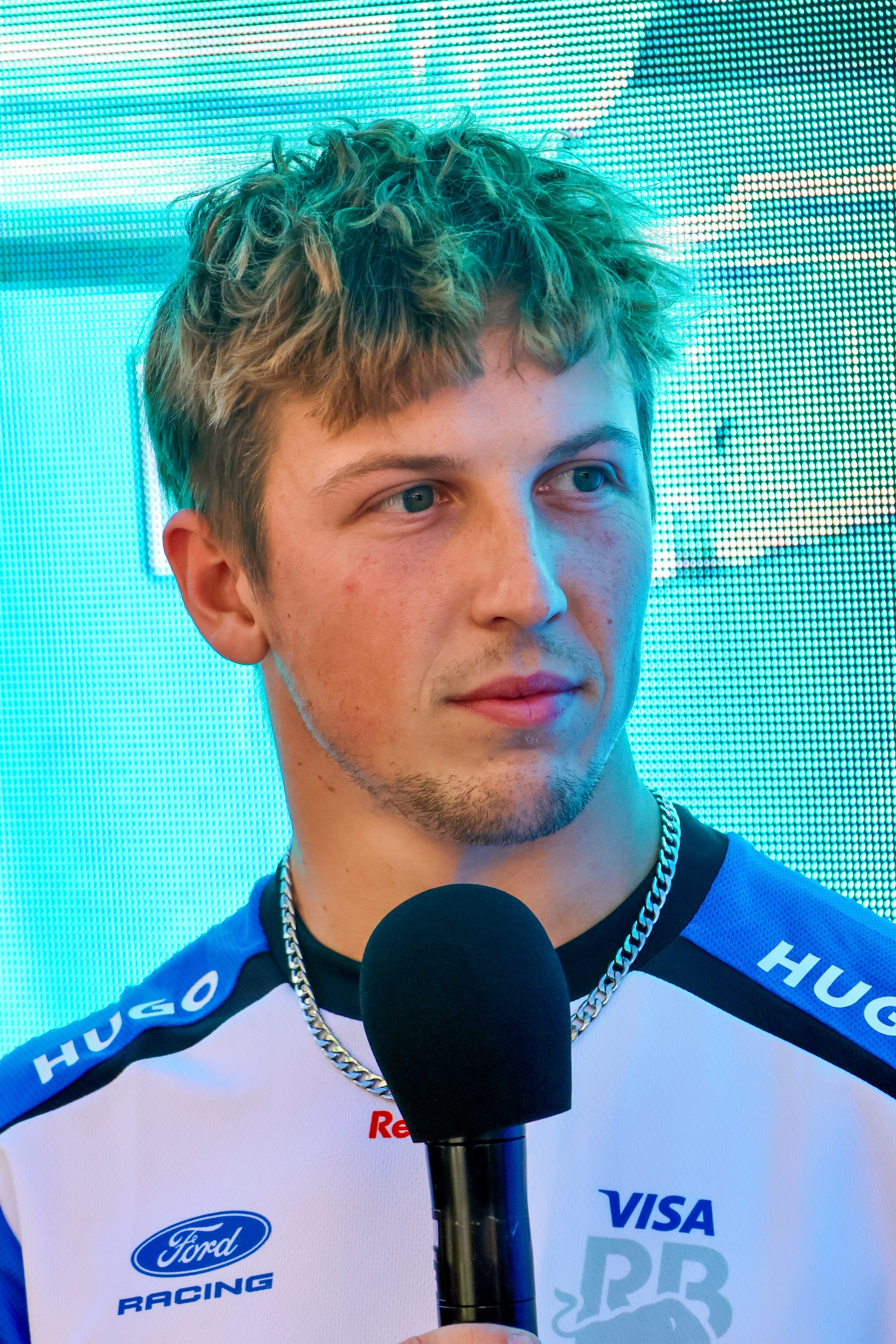Liam Lawson smiling with fans at a Red Bull fan zone in Melbourne