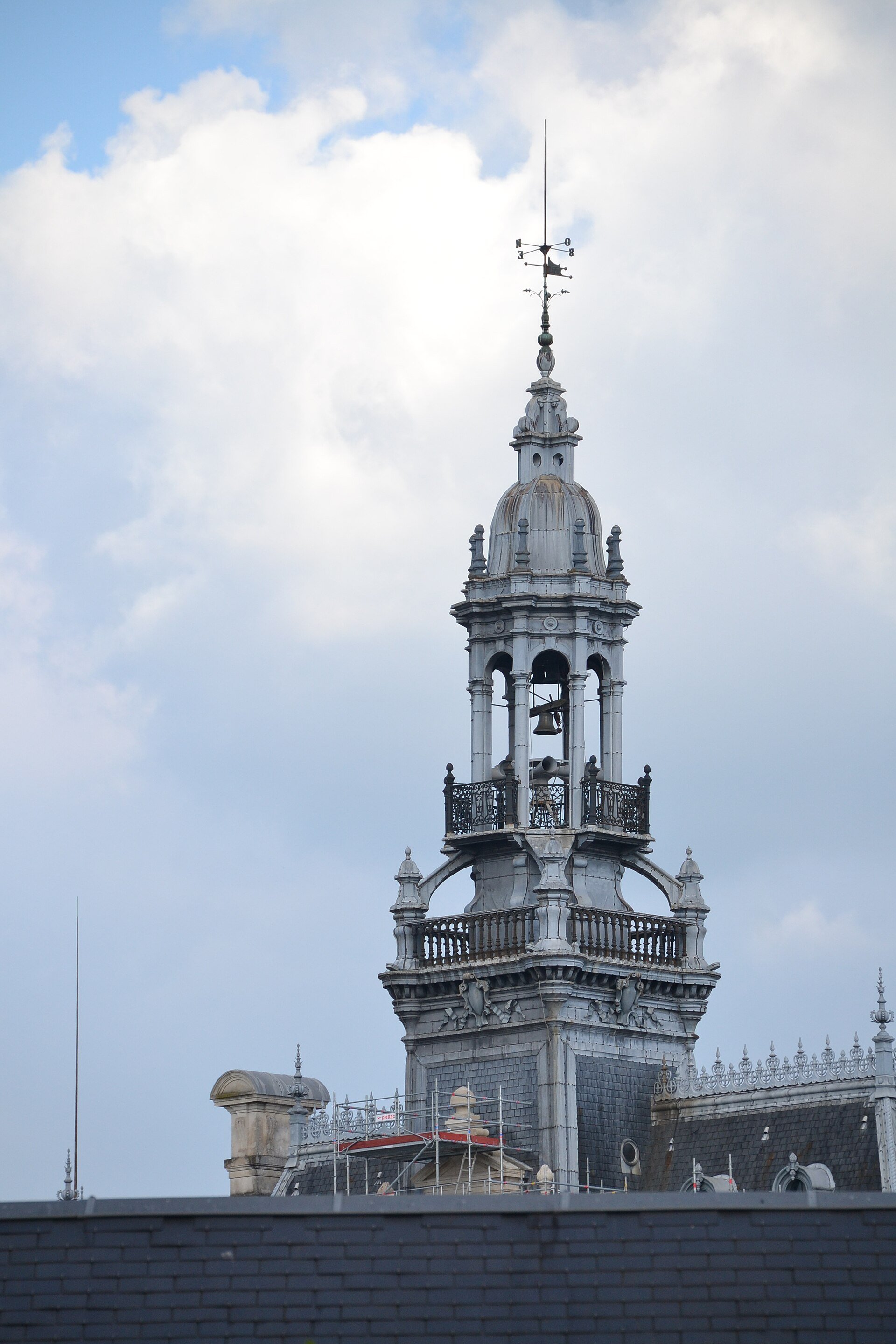 The tall bell tower of Limoges town hall against a blue sky, before the fire