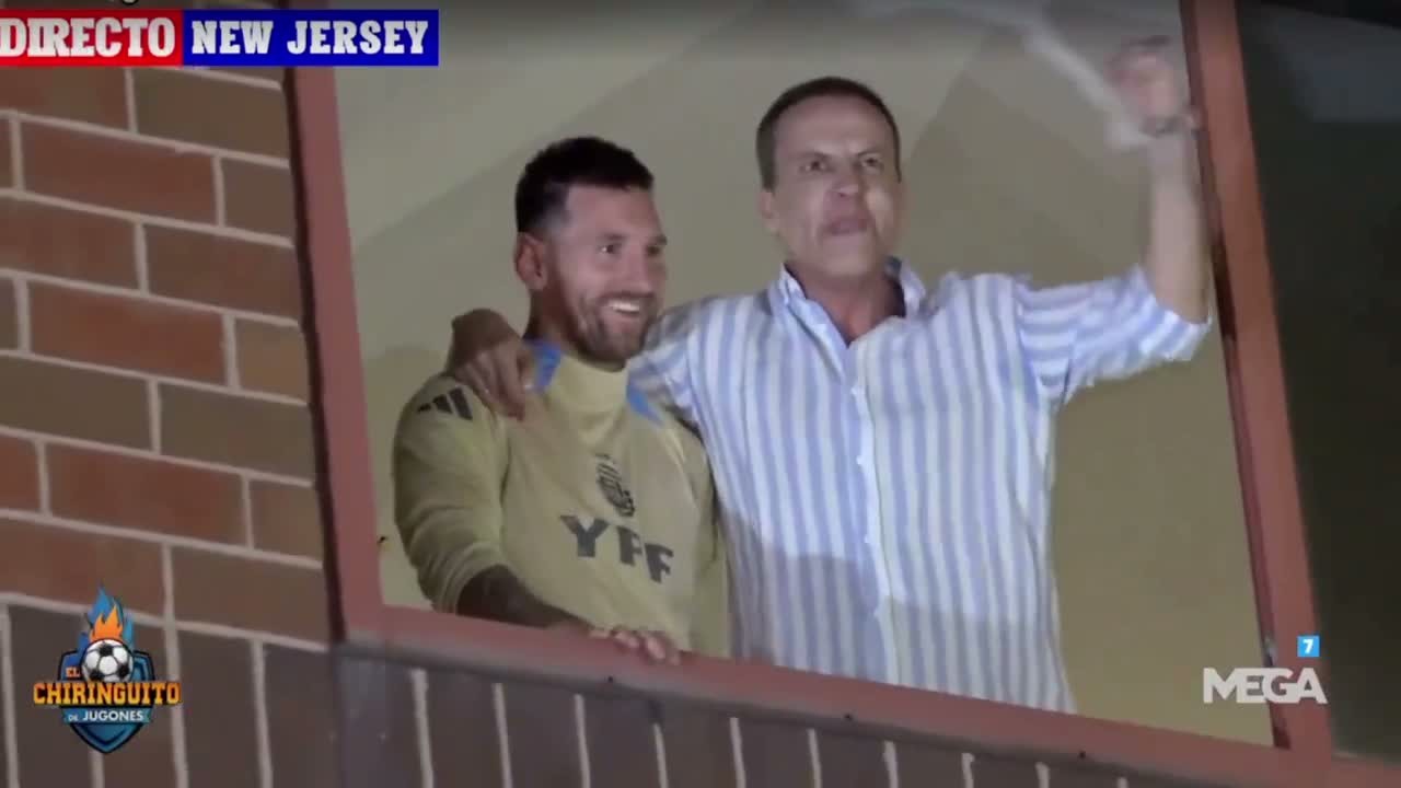 Lionel Messi in an Argentina training top at a hotel window, with Spanish TV pundit Cristóbal Soria's arm around his shoulders
