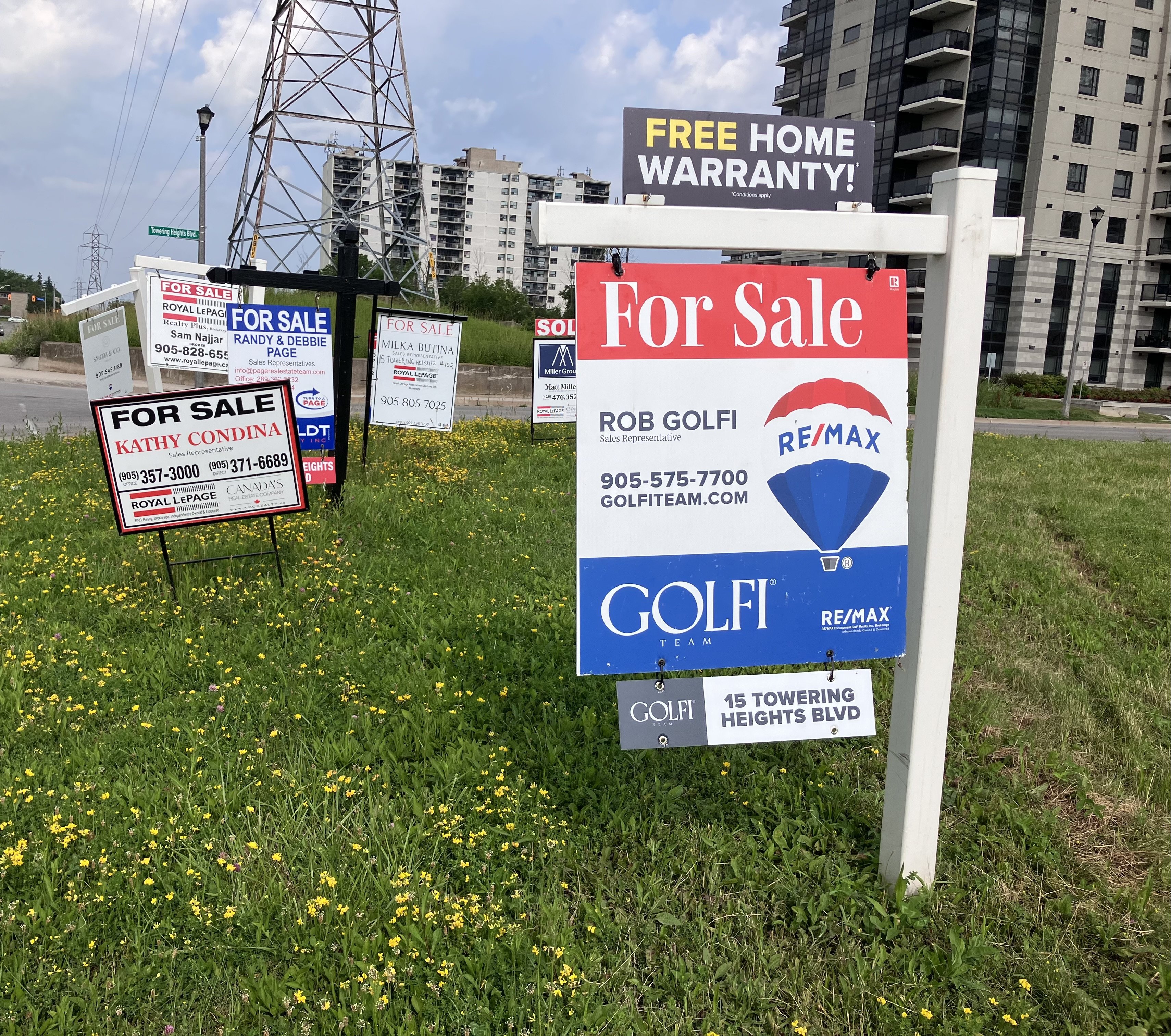 Real estate for sale signs outside homes