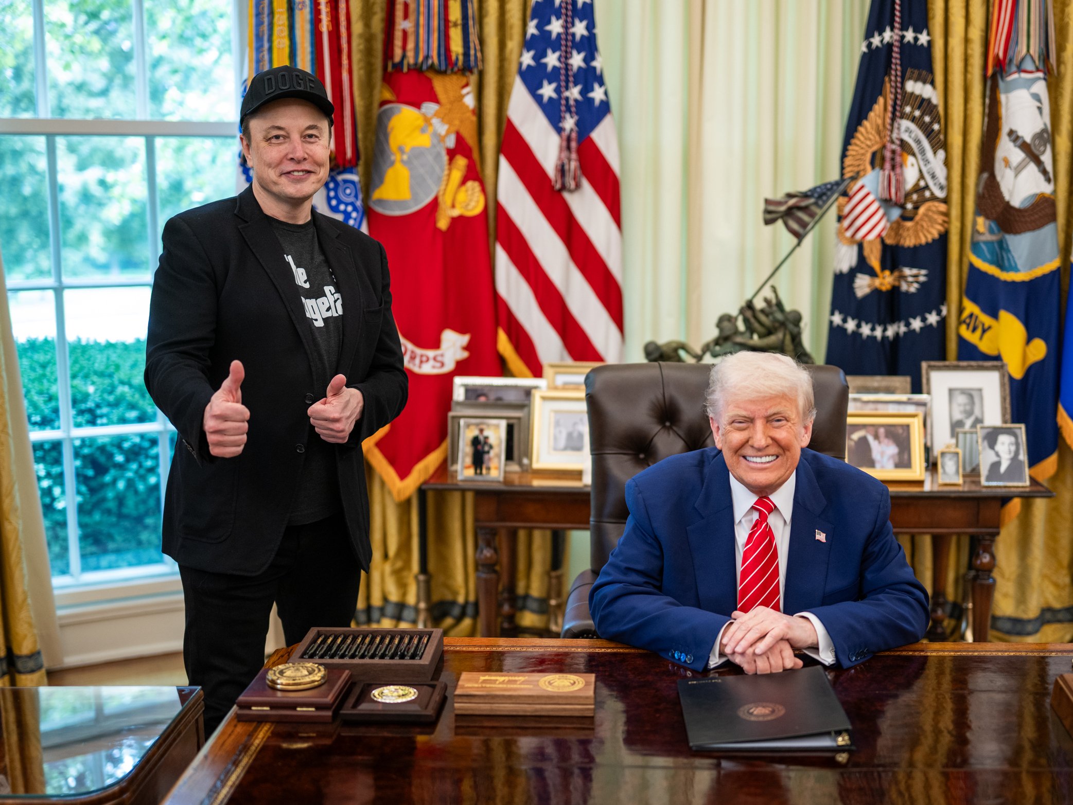 Donald Trump and Elon Musk standing side by side at a White House press event