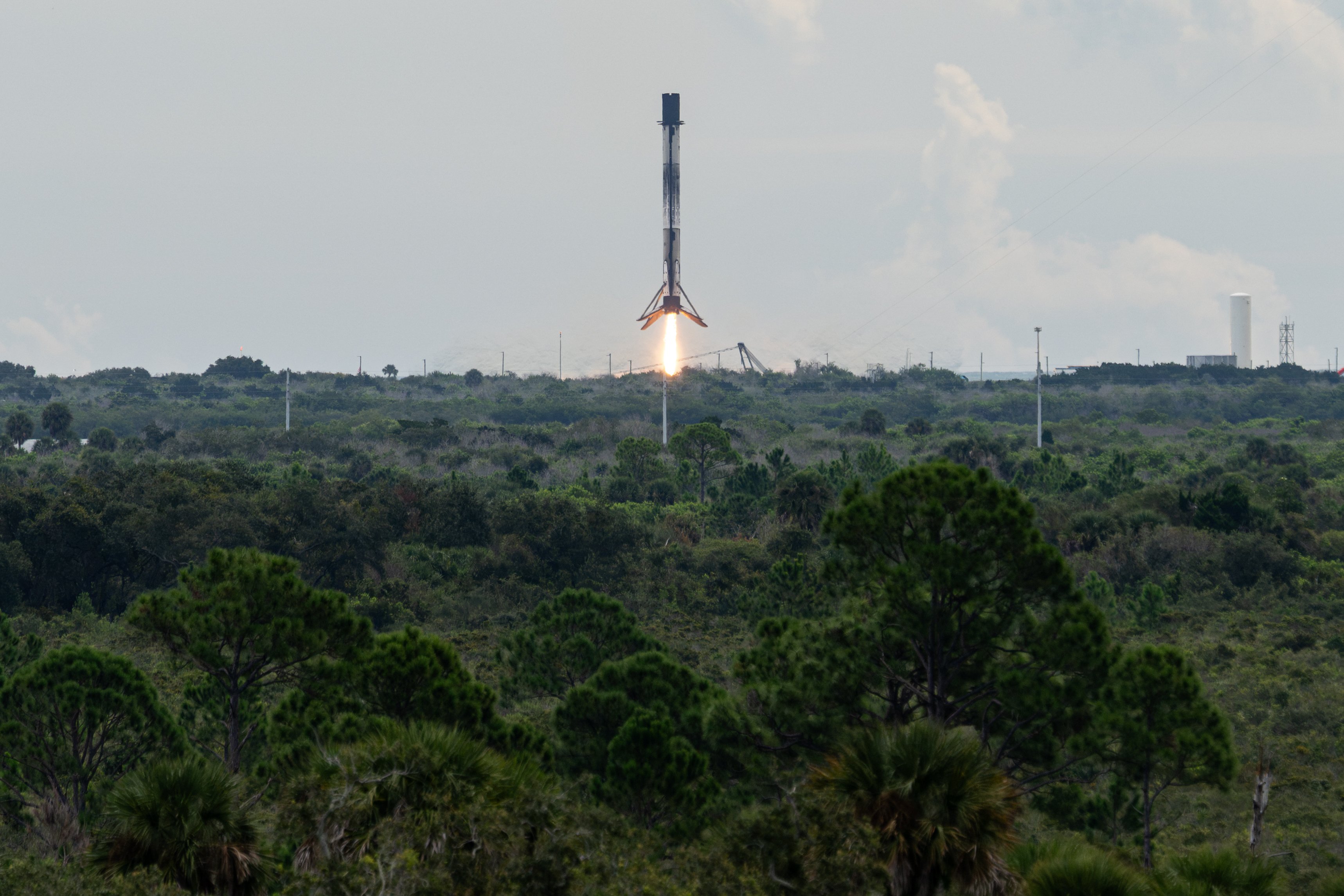A SpaceX Falcon 9 booster landing on its legs at Cape Canaveral, Florida
