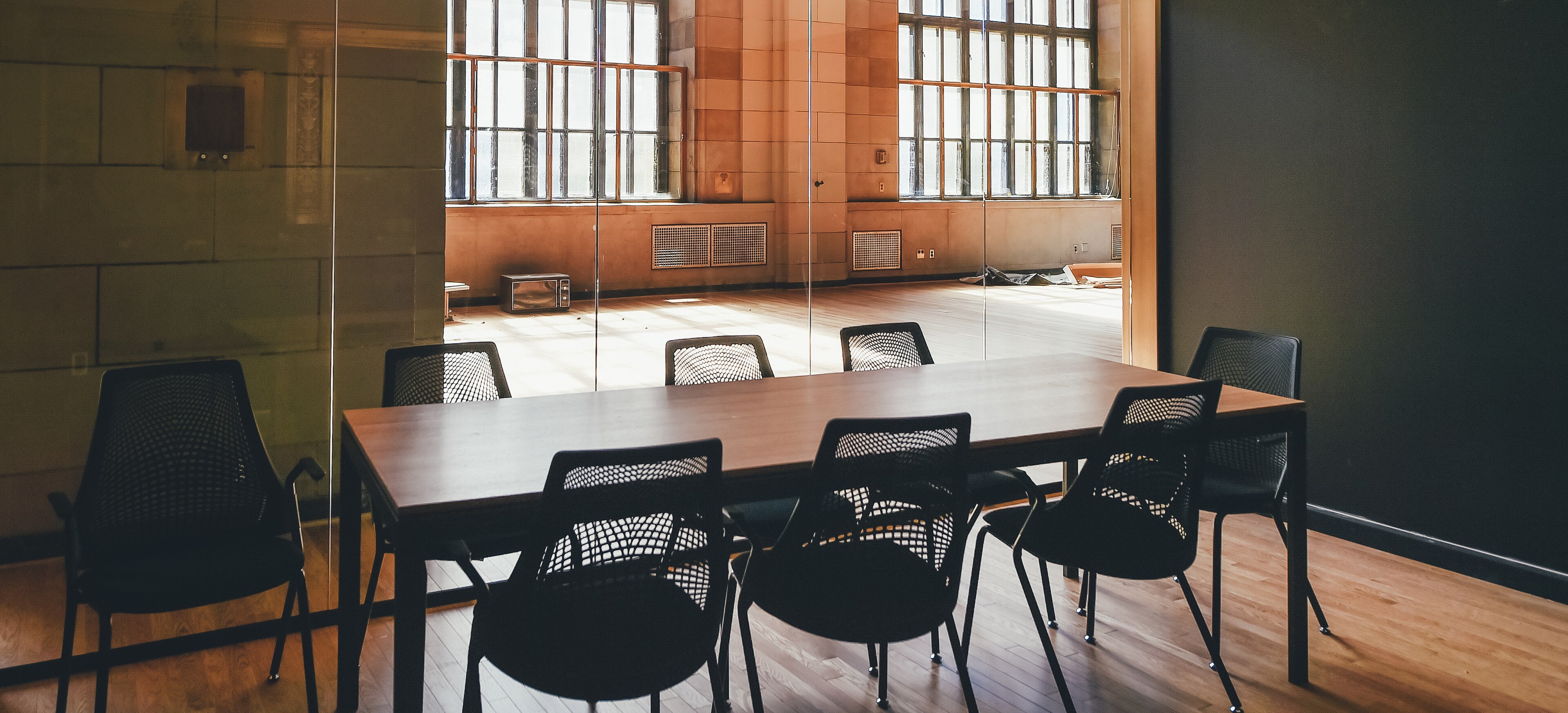 A small conference room with a table and chairs