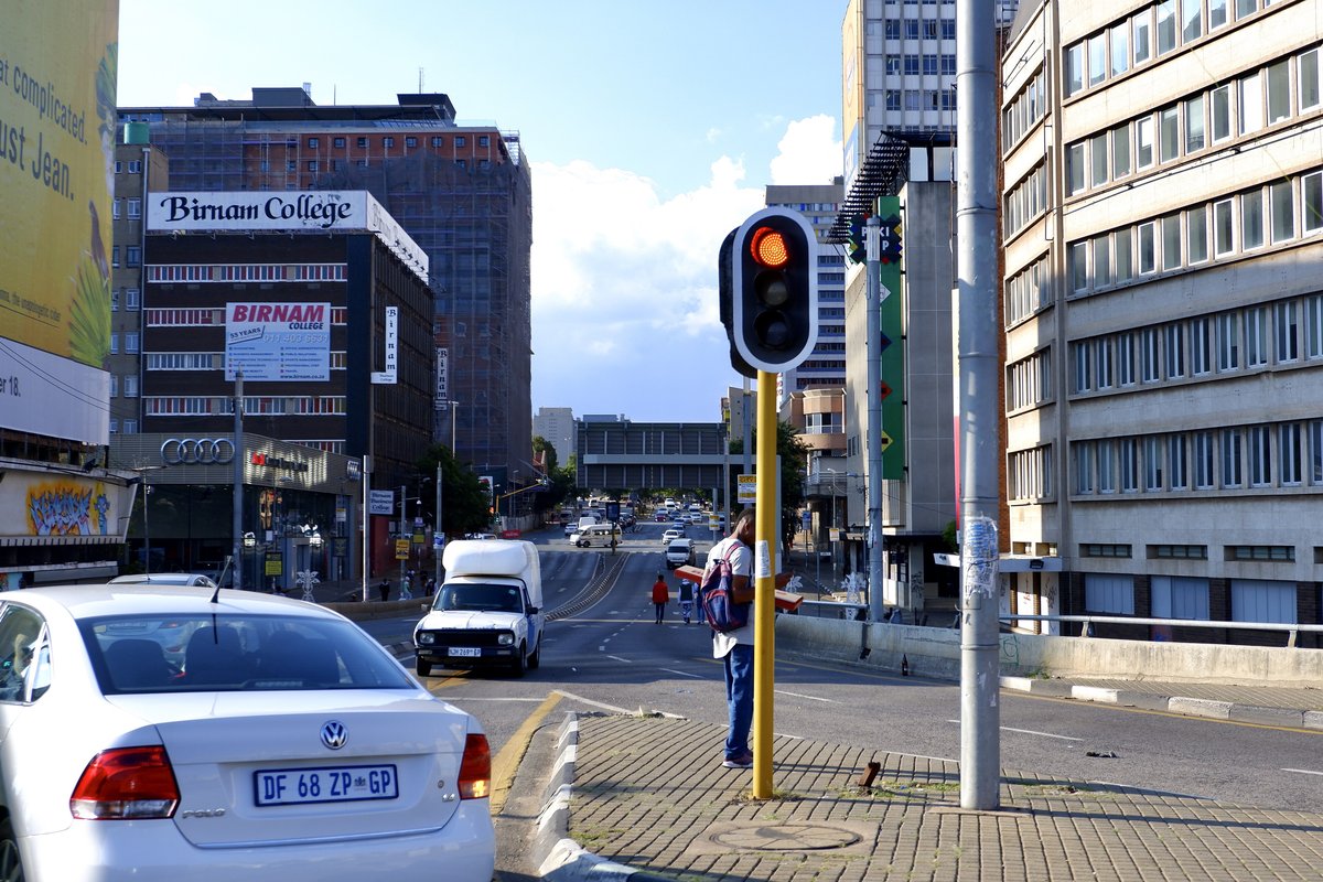 A busy Johannesburg intersection with cars waiting at a red light
