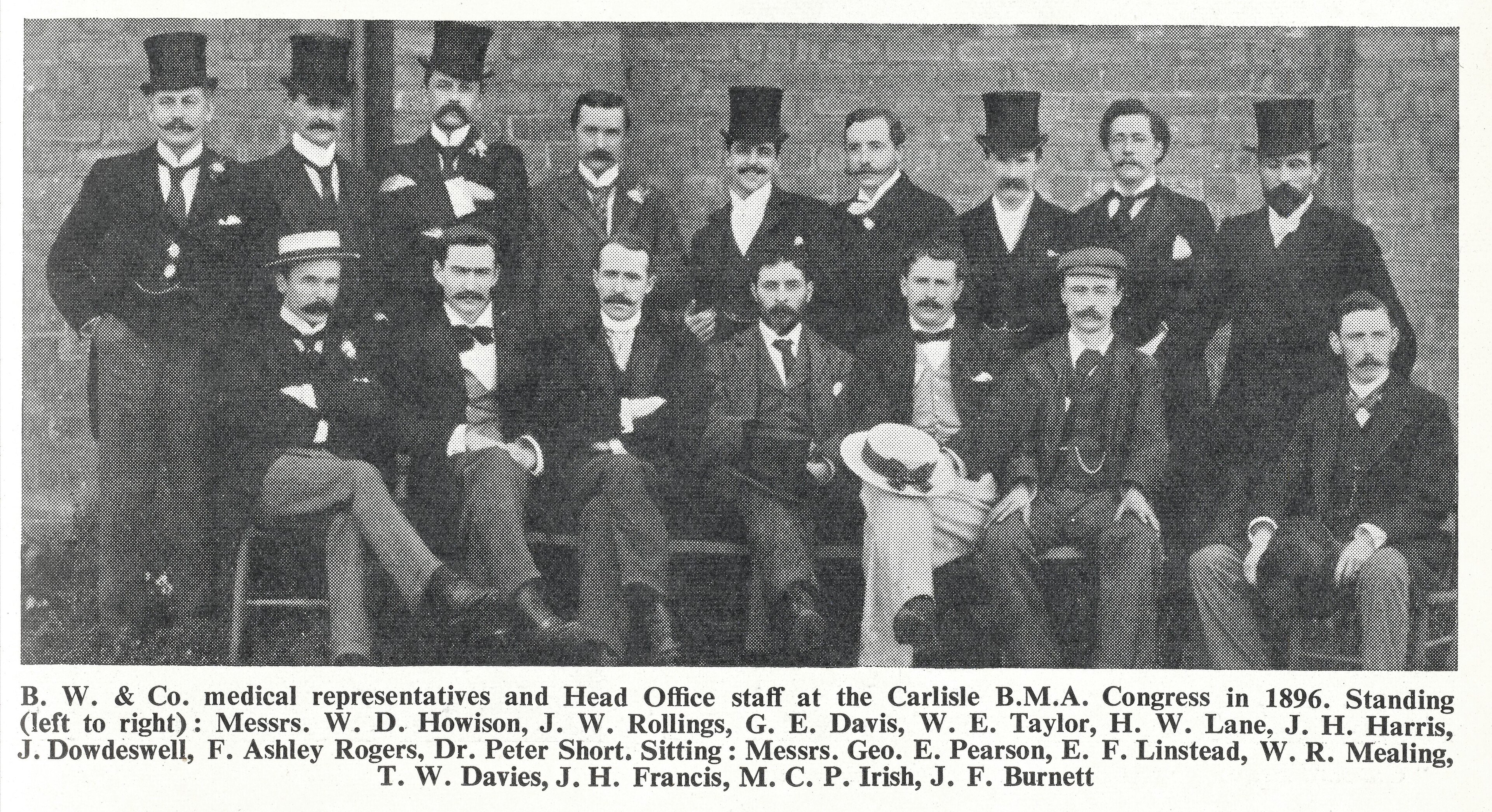 A group of Victorian medical representatives and office staff posing in suits and hats in 1896