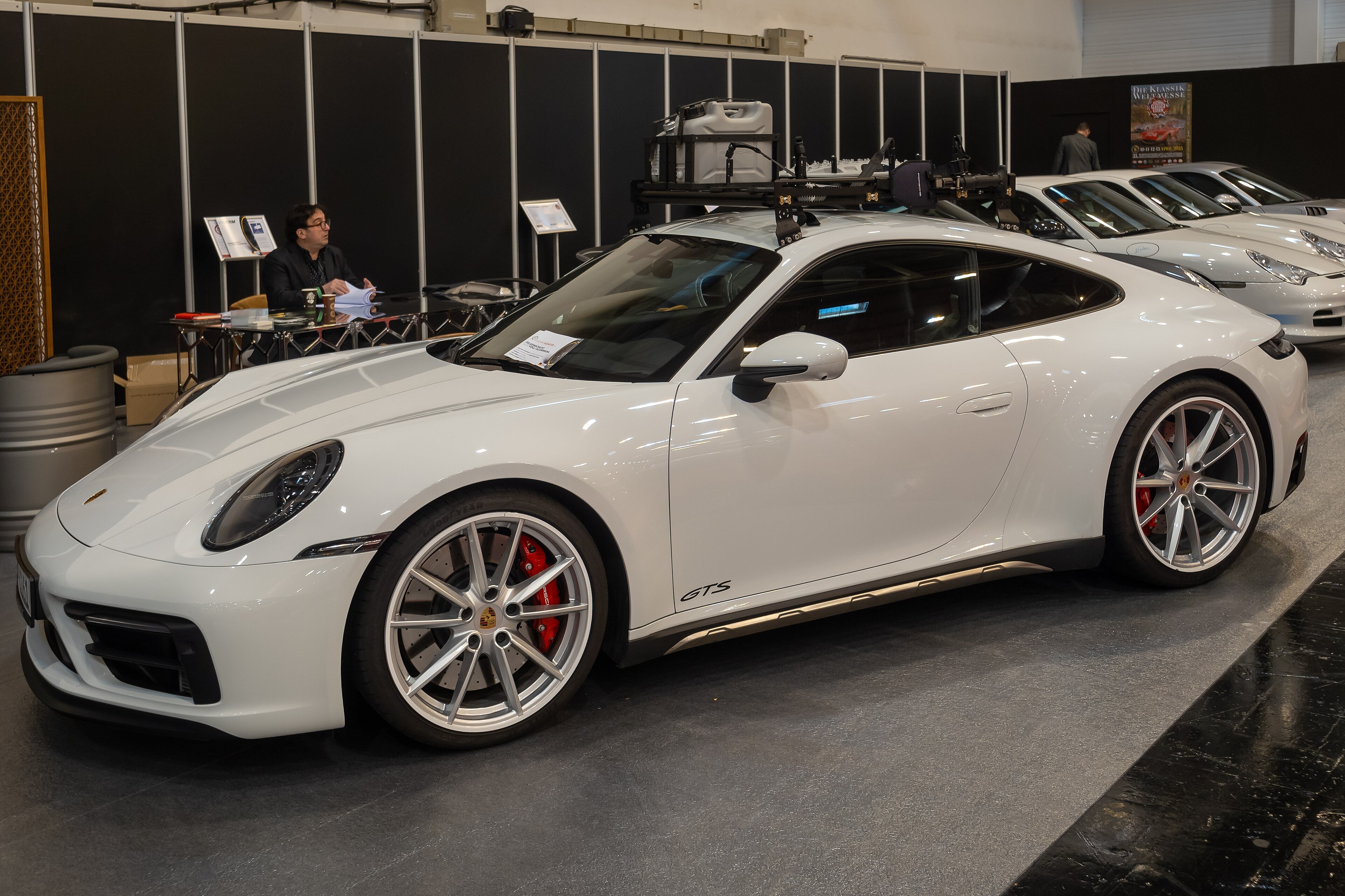 A silver Porsche 911 Carrera GTS on display at the Essen Motor Show in 2024
