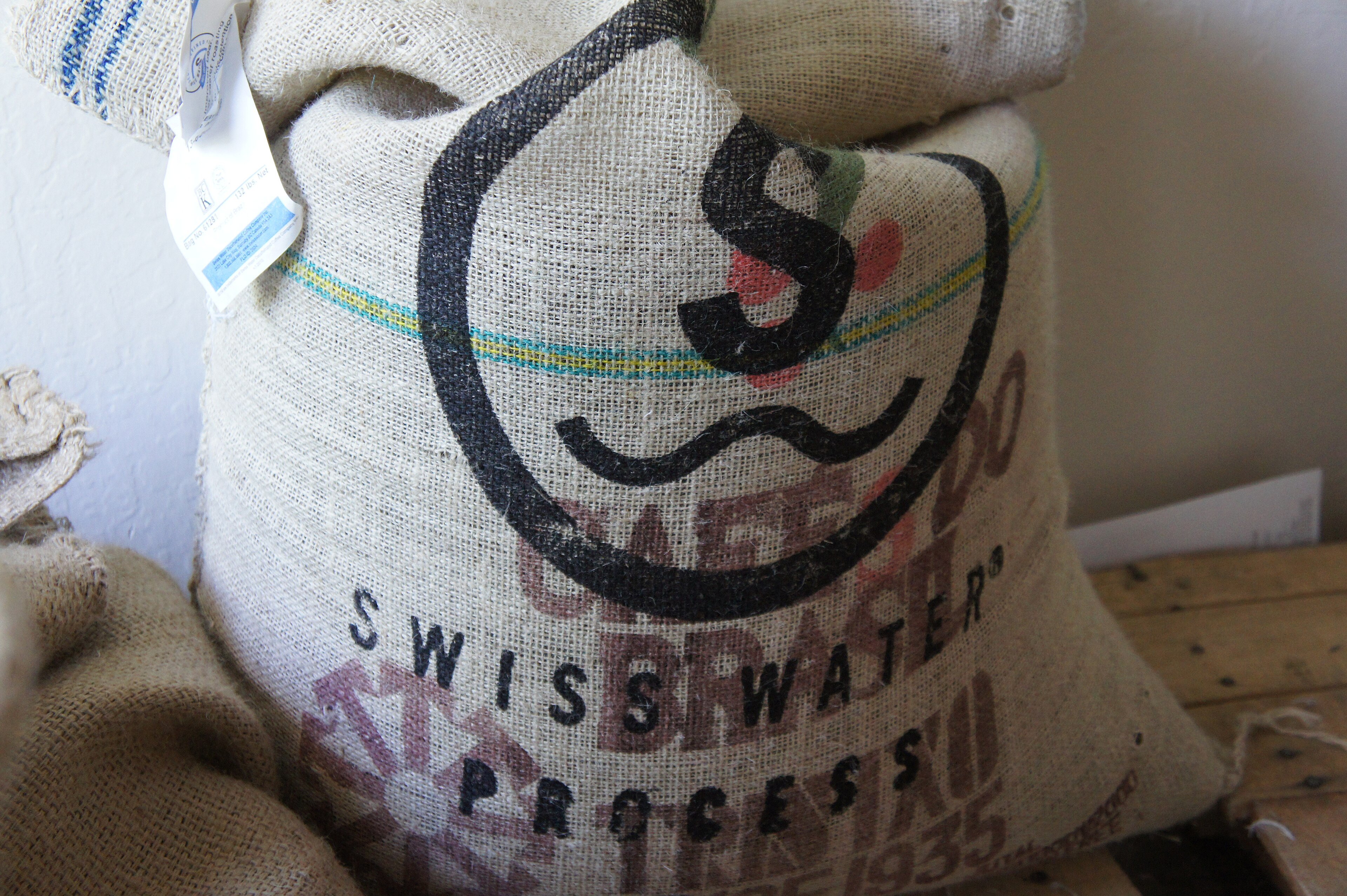 Green decaffeinated coffee beans in a sack