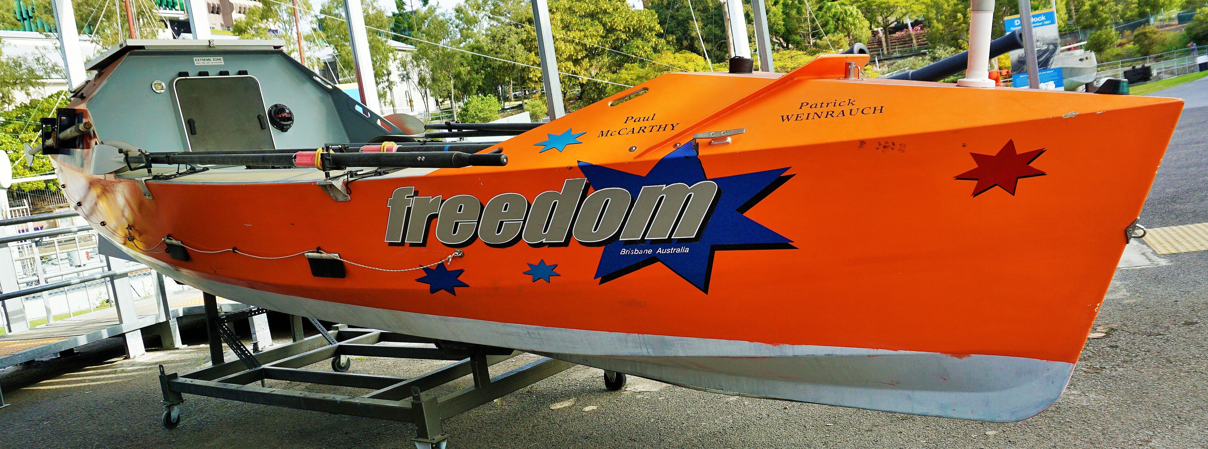 An ocean rowing boat on display, the kind used for Atlantic crossings, with a small cabin at each end