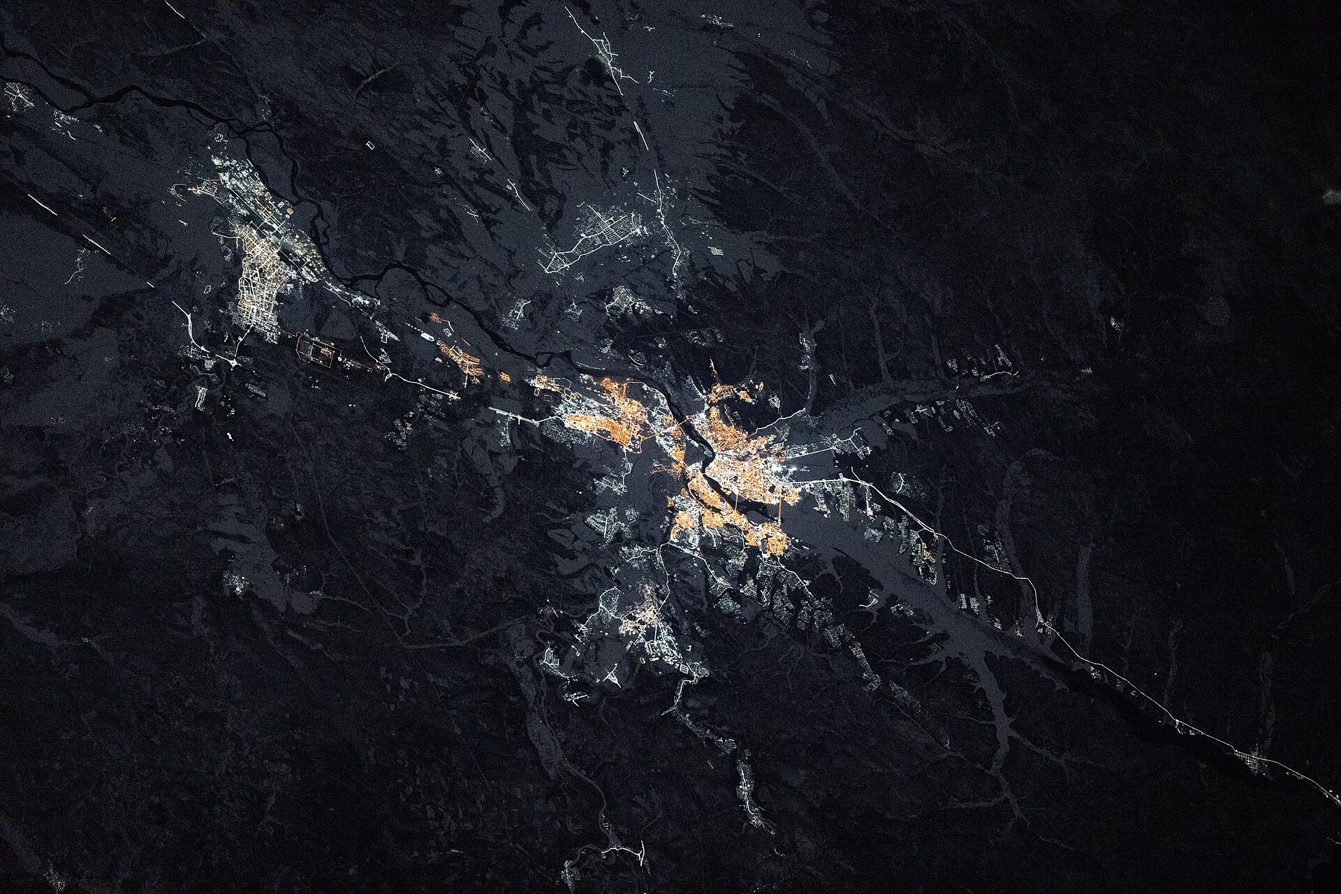 Night view from the International Space Station of the lit-up city of Irkutsk split by the Angara River