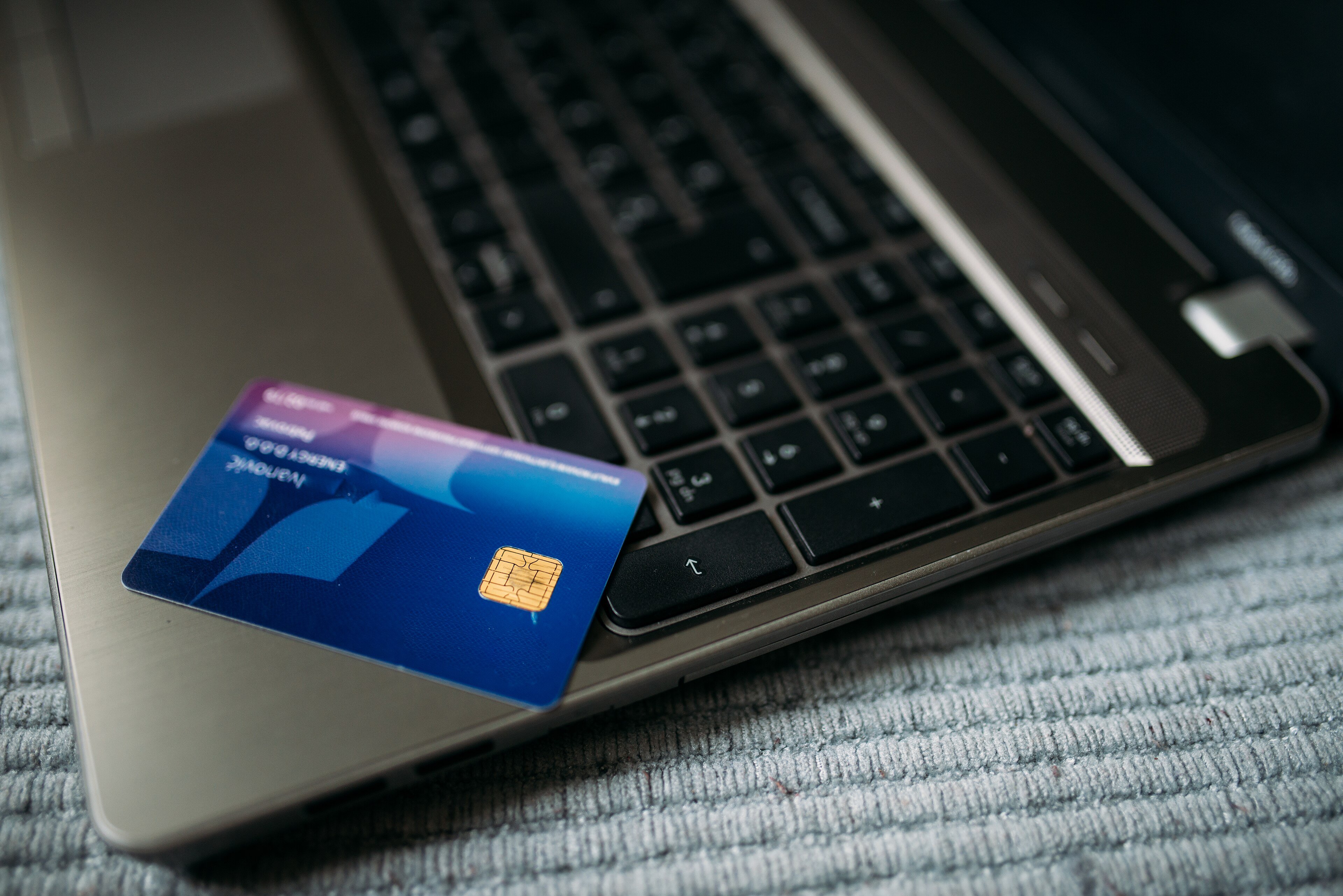 A bank card resting on a laptop keyboard