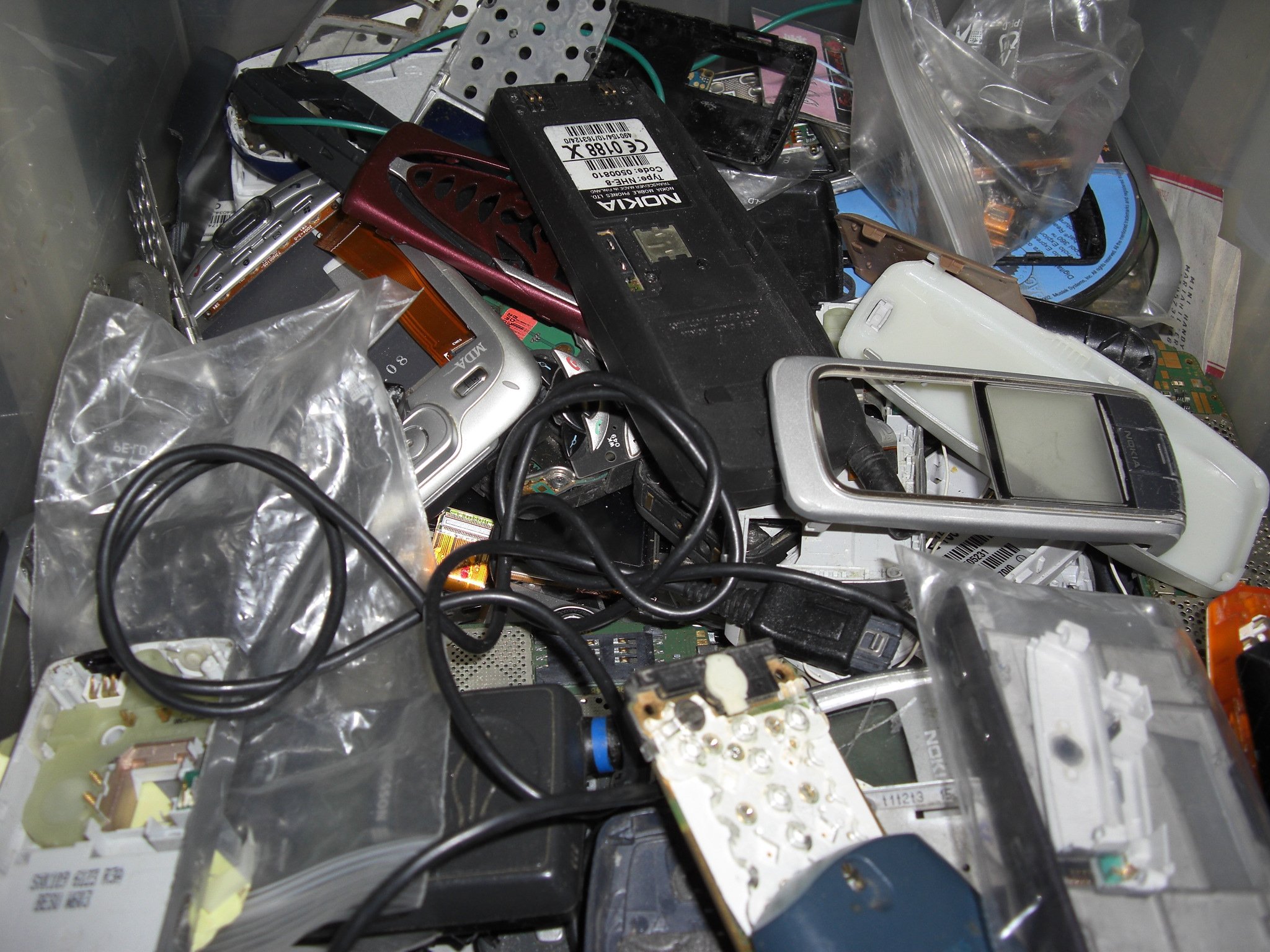 A pile of old, broken mobile phones collected for scrap