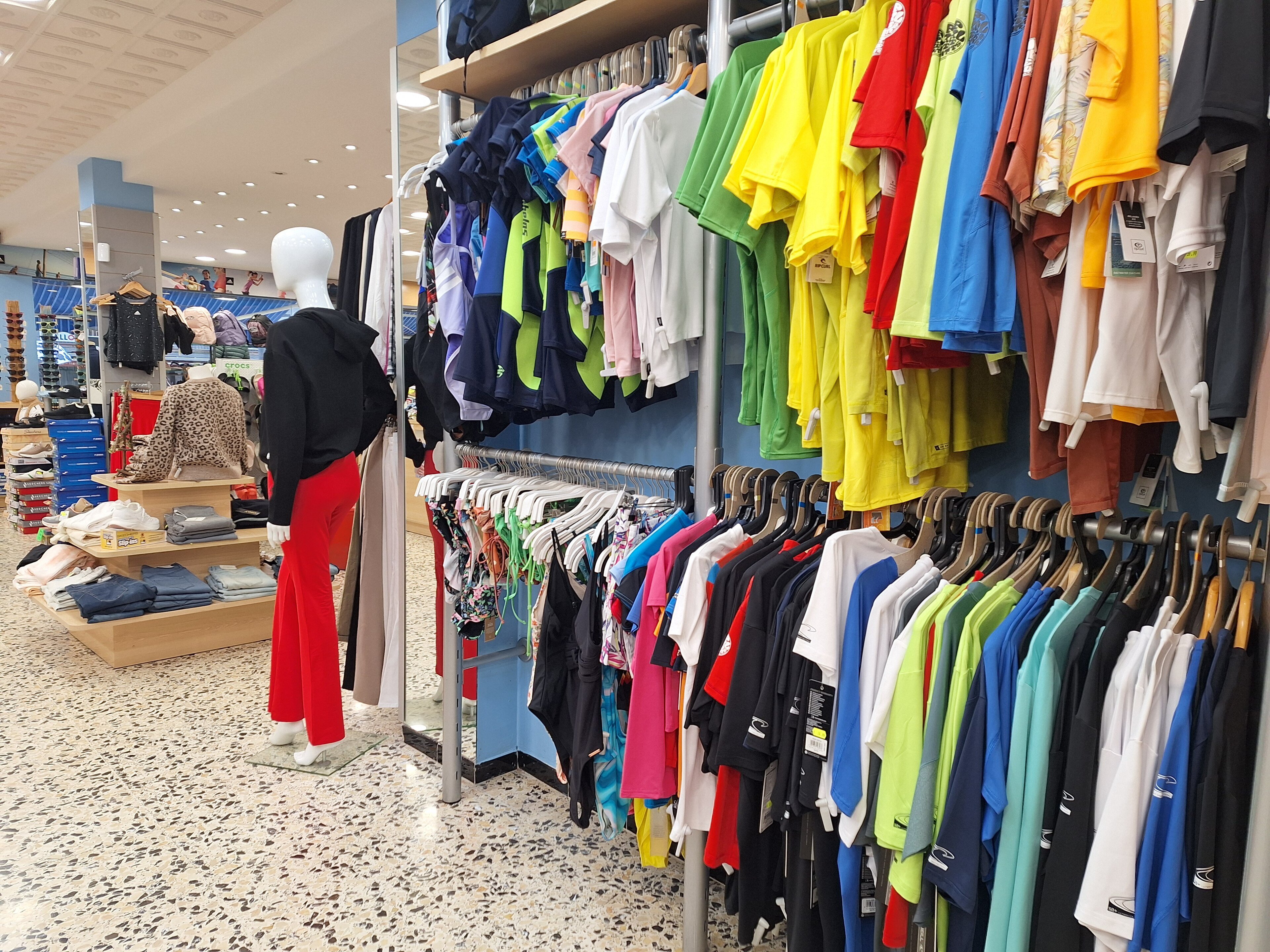 Racks of T-shirts inside a clothing store