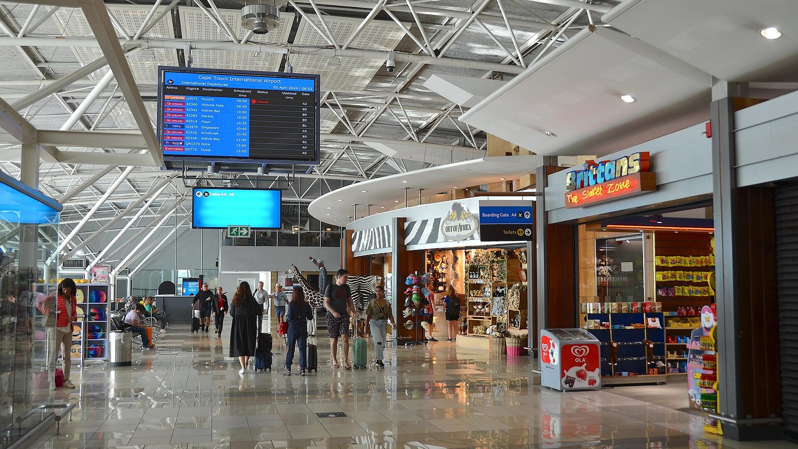 Travellers walking through the international departures hall at Cape Town International Airport