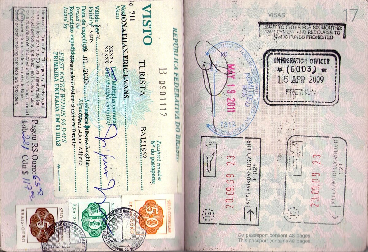 Visa and entry stamps from several countries on the pages of a passport