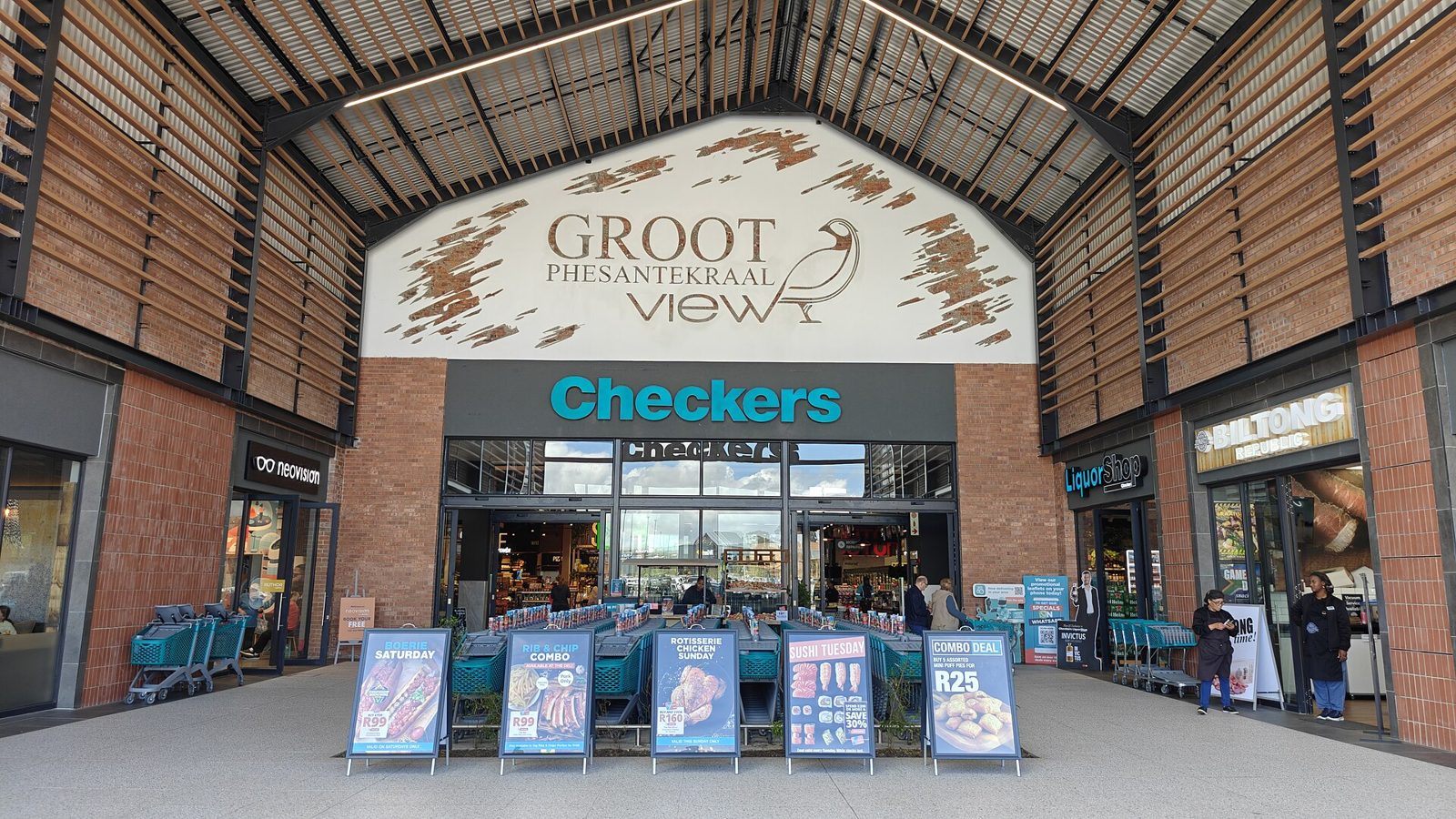 The entrance to a Checkers supermarket in Durbanville, Cape Town, with hot food deal signs out front